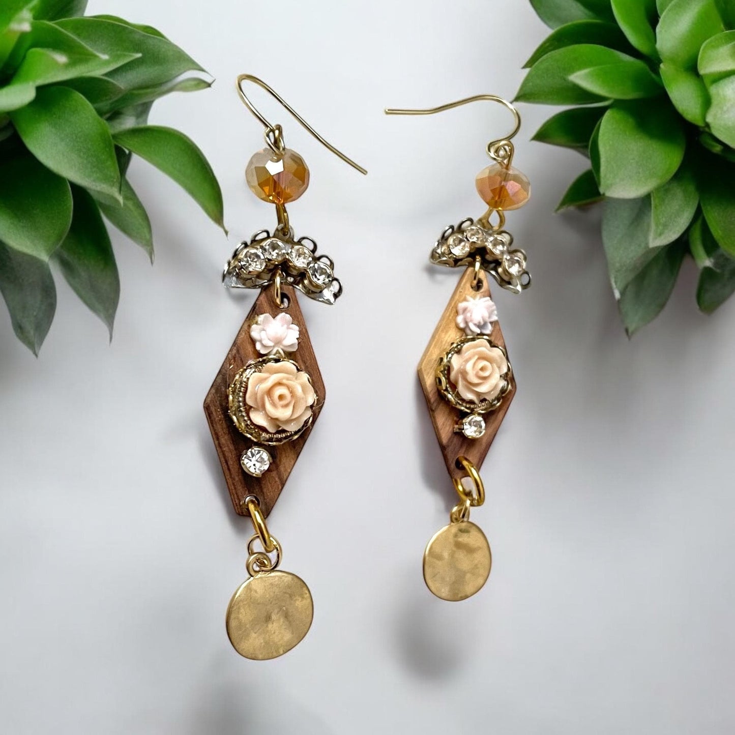 Dangle earrings with wood diamonds from a broken vintage rosary, etched roses, rhinestone, crystals and hammered discs. Sterling ear wires.
