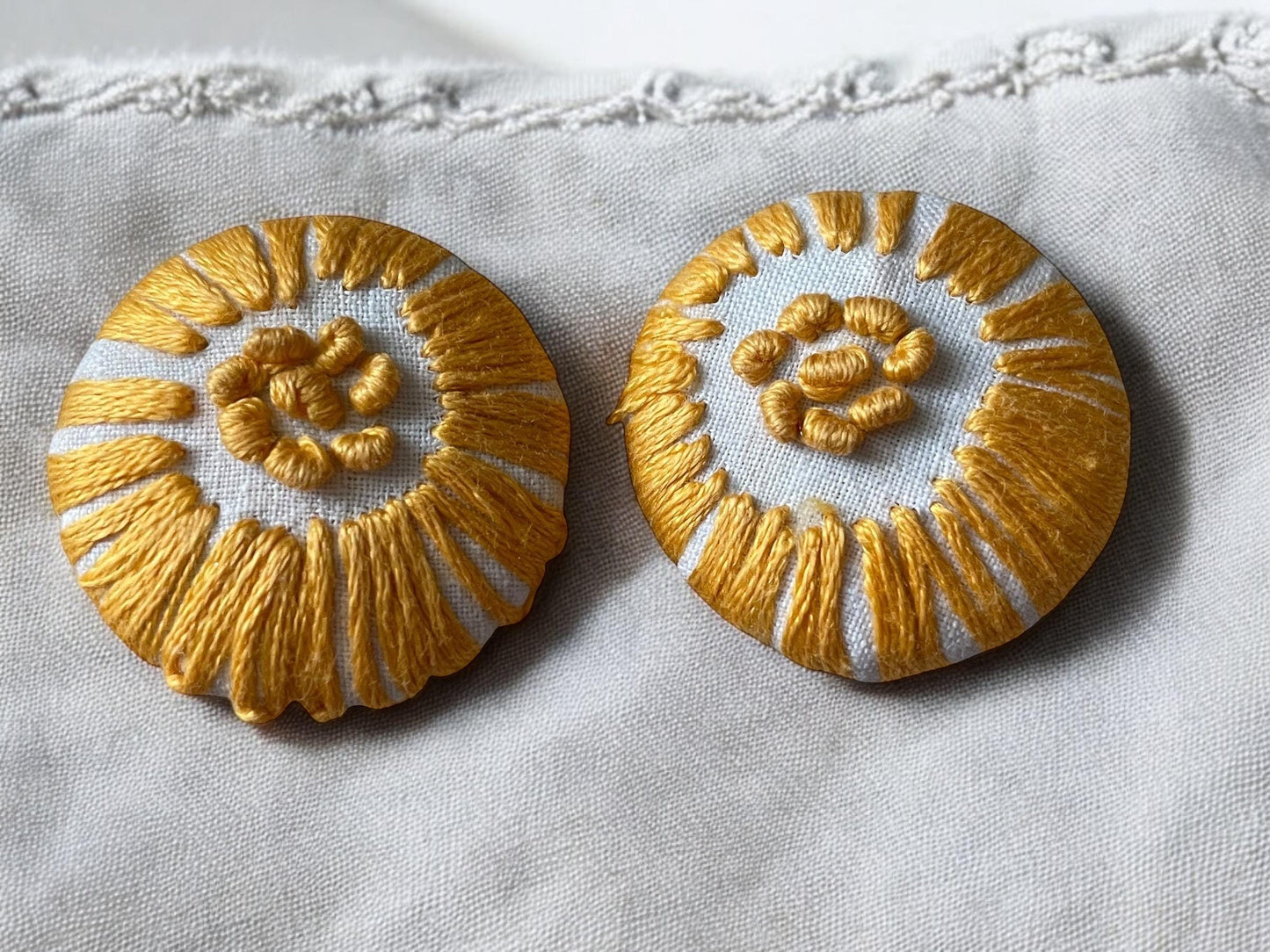 Choice of stud earrings, dangle earrings, hair combs, shanked buttons or pins all hand made from a vintage linen embroidered table runner