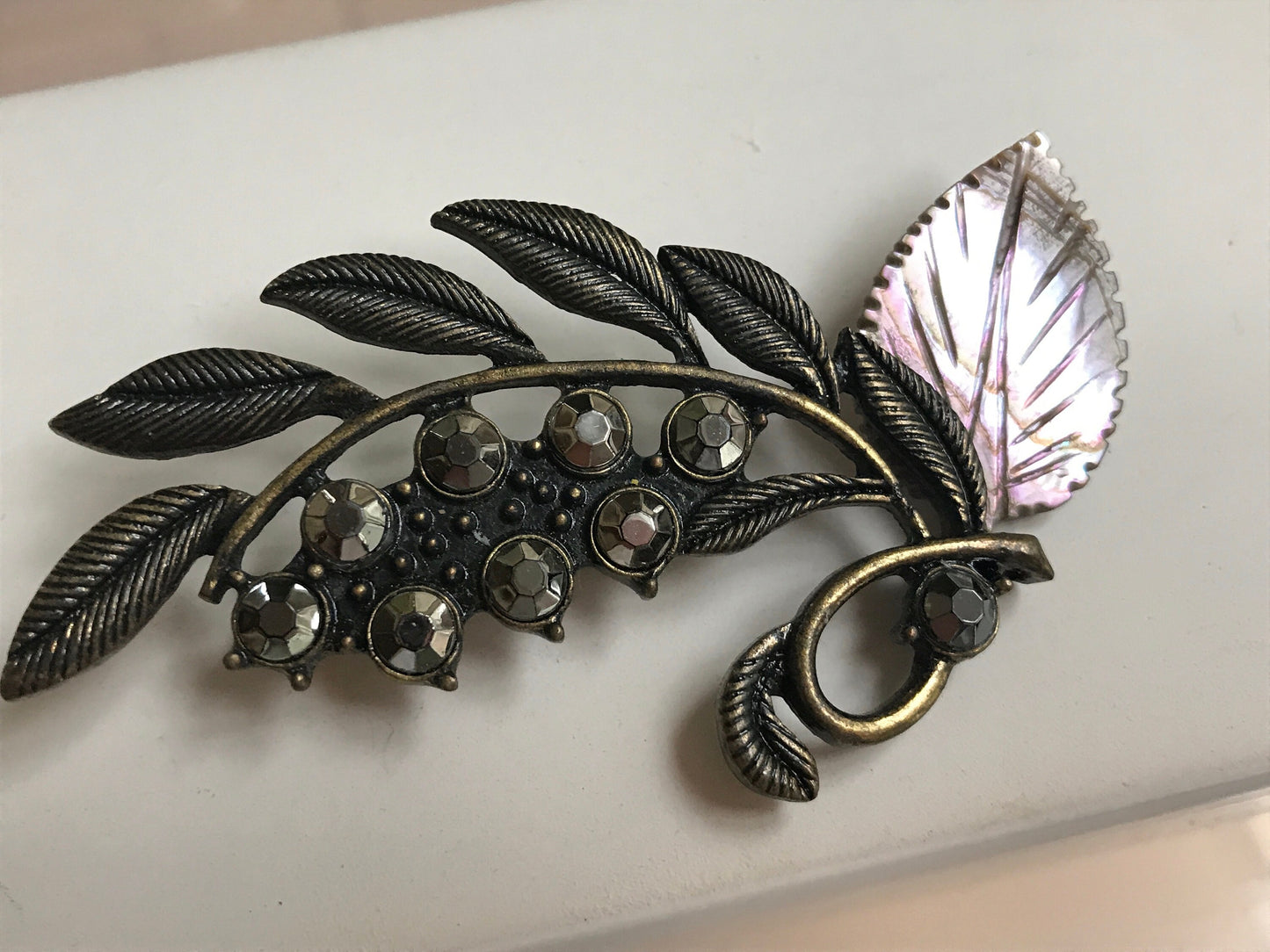 Stunning and unique vintage metal and rhinestone pin with abalone leaf