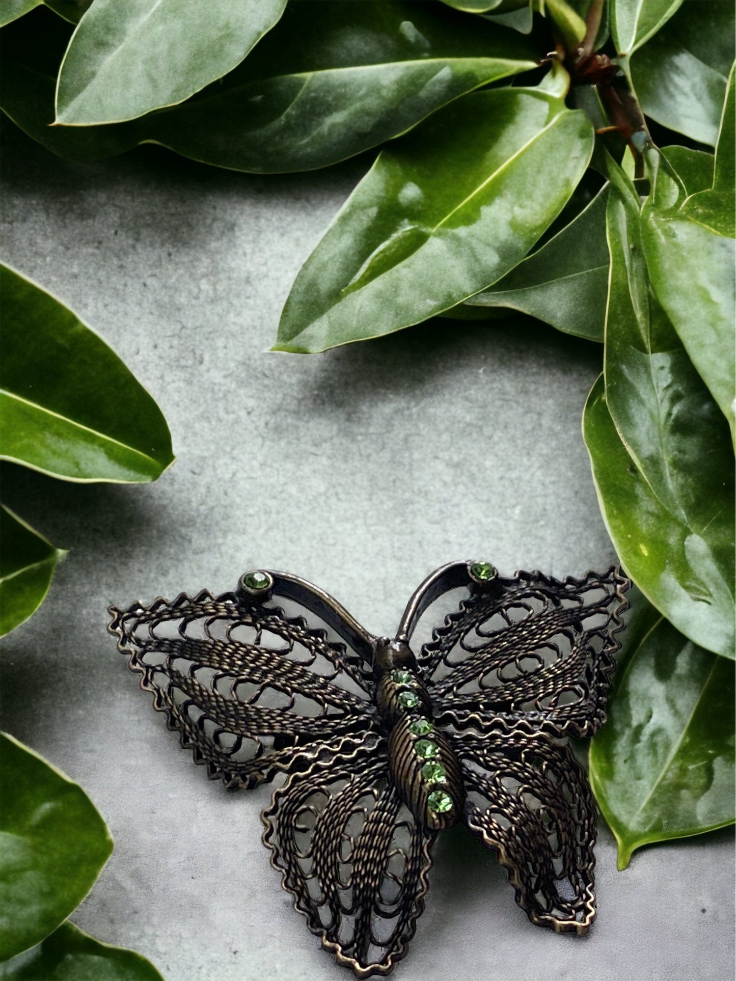 Detailed vintage filigree butterfly pin with tiny emerald green rhinestones