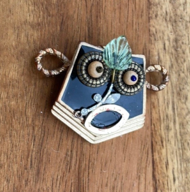 This monkey is a really cool assemblage art piece - it can be transformed into a necklace pendant, pin, magnet, small ornament or ring