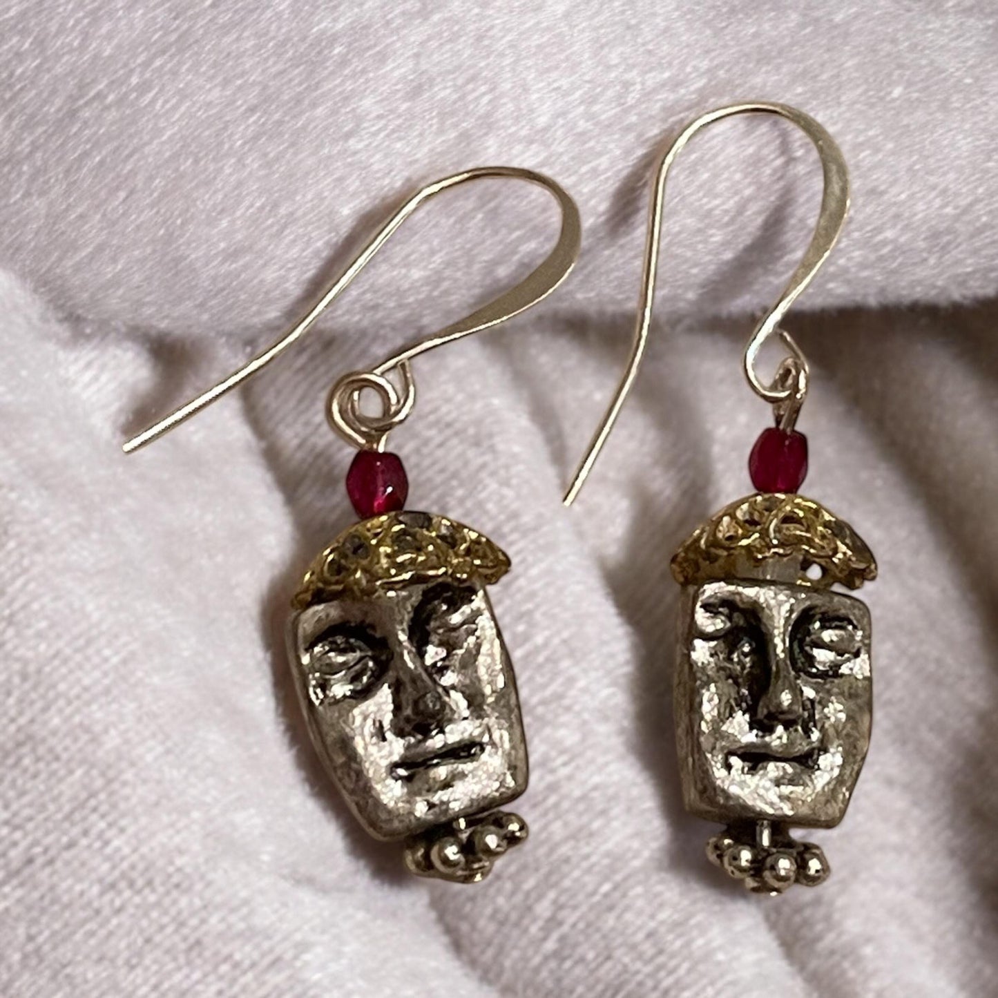 Unique silver tone face earrings with mixed metal and red crystals