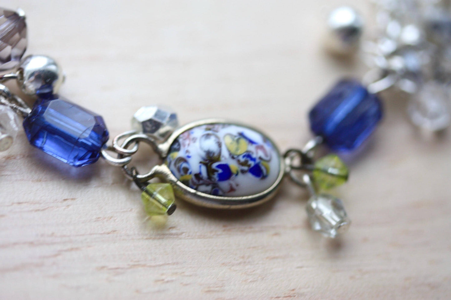 Handmade bracelet featuring a unique vintage art glass cabochon, royal blue faux crystals, yellow, pearl and clear crystal dangles - 7"