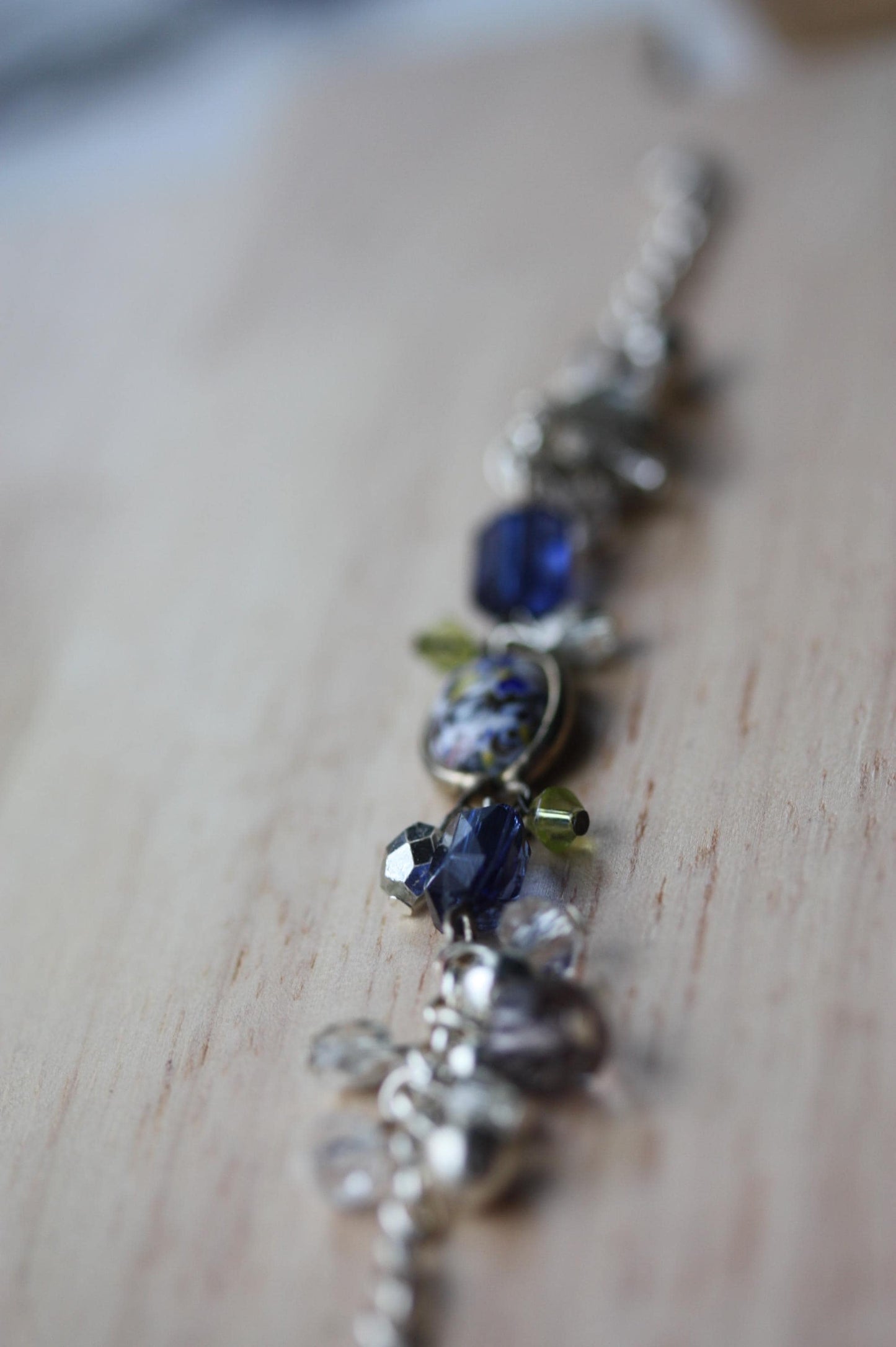 Handmade bracelet featuring a unique vintage art glass cabochon, royal blue faux crystals, yellow, pearl and clear crystal dangles - 7"