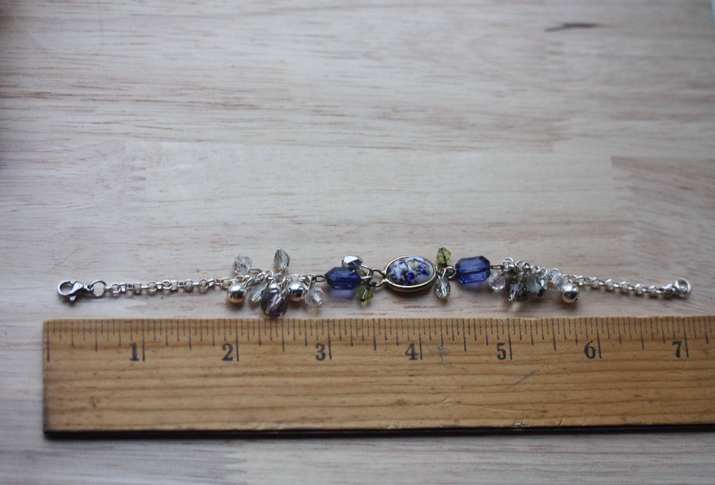 Handmade bracelet featuring a unique vintage art glass cabochon, royal blue faux crystals, yellow, pearl and clear crystal dangles - 7"