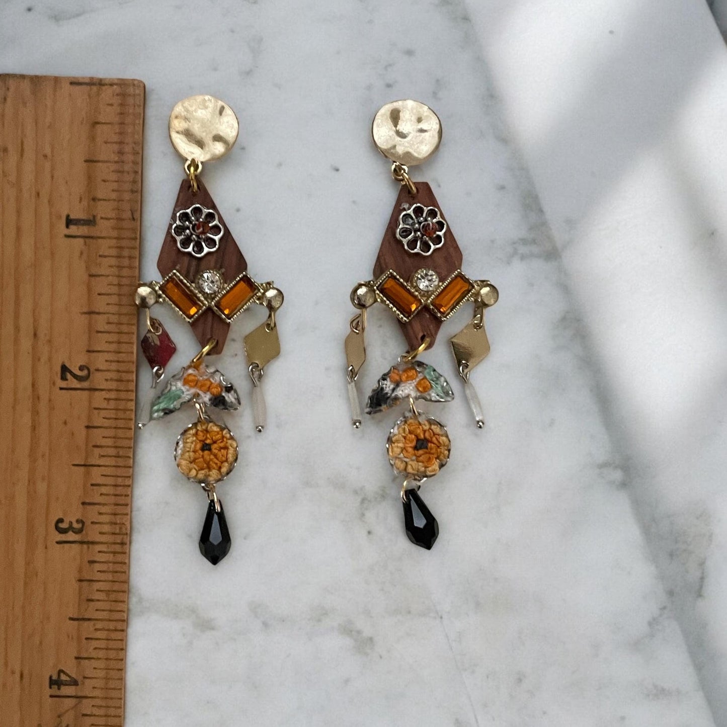 Mixed media earrings made with embroidery from a vintage linen table runner,  rosary wood, hammered metal, glass tubes, orange rhinestones