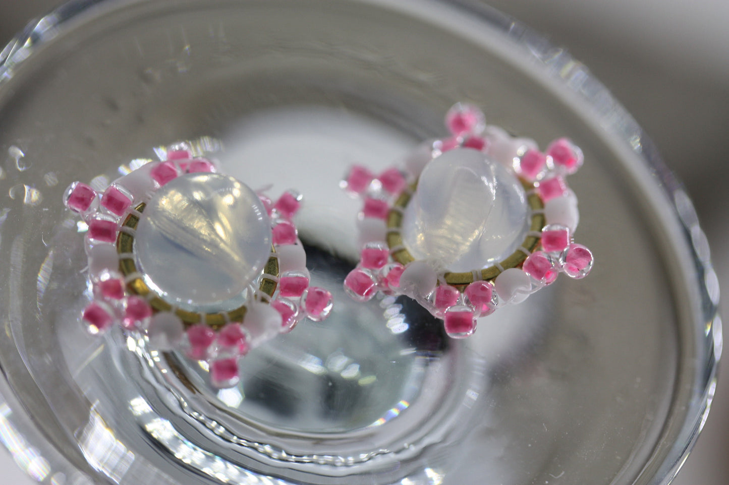 Hand beaded stud earrings - pink and white beadwork around transluscent opalescent glass bead