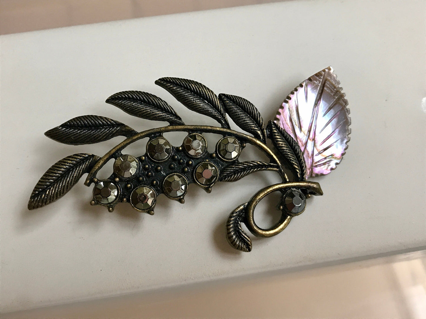 Stunning and unique vintage metal and rhinestone pin with abalone leaf