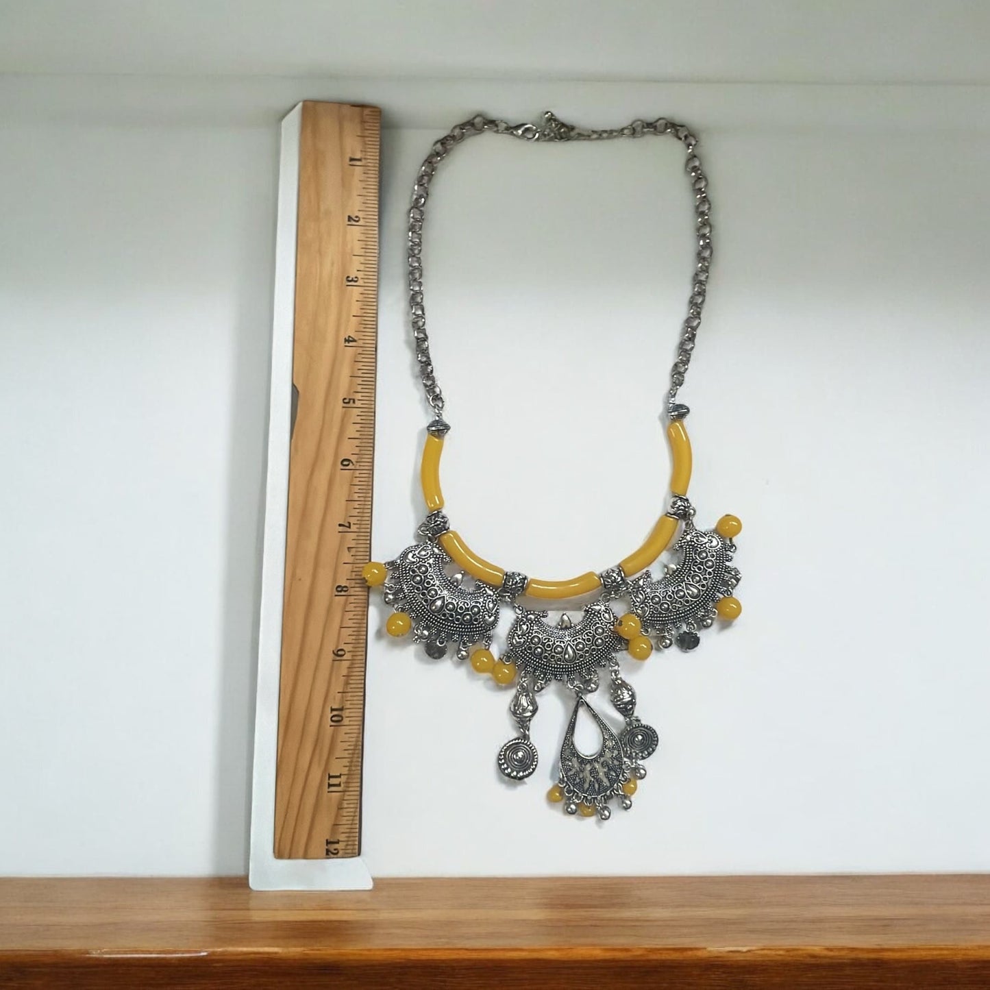 Exotic Indian style necklace with yellow beaded balls/tubes and ornate silver trim