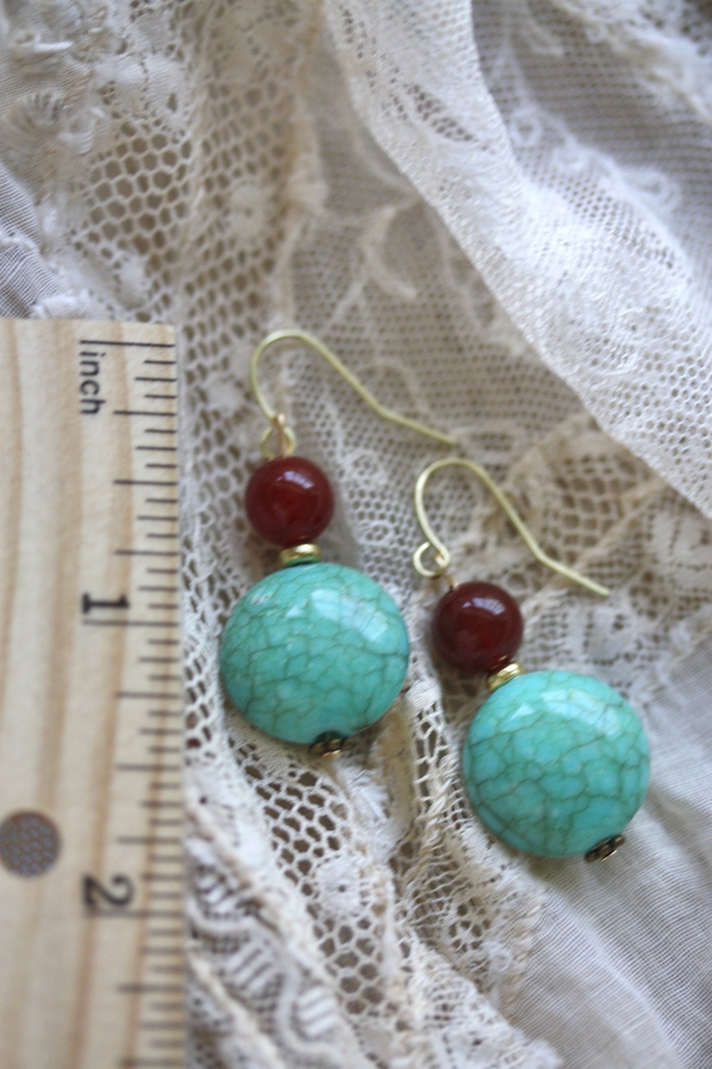 Dangle earrings made of faux turquoise and deep red glass