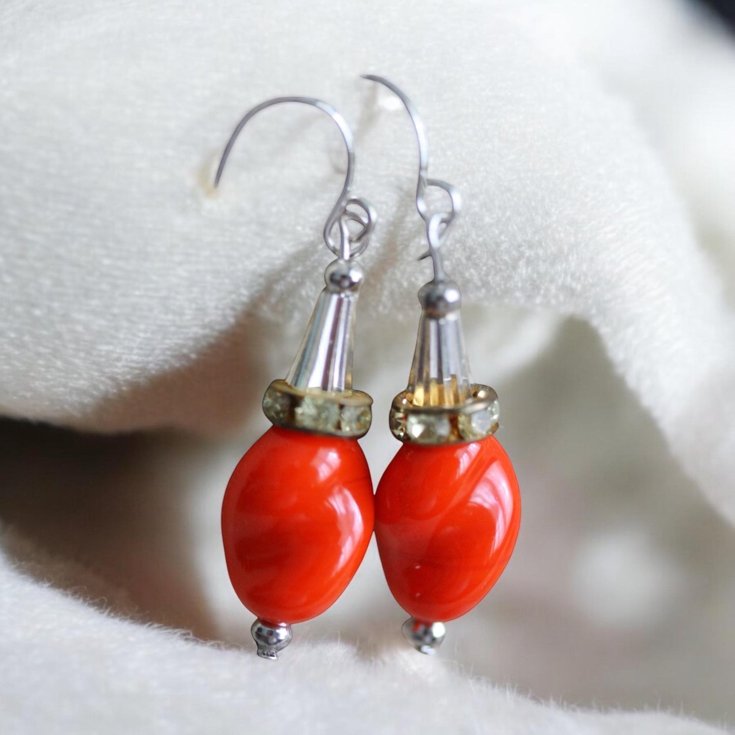 Unique dangle earrings featuring orange free form slightly twisted vintage glass, metal cone beads and rhinestone spacers