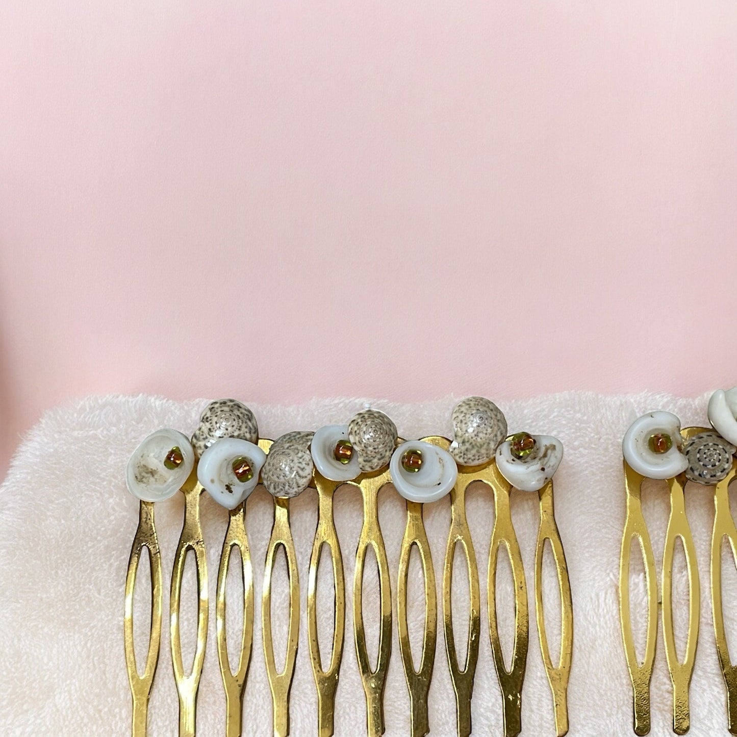 Pair of stunning hand beaded white and striped shell hair combs with burnt orange-gold glass seed beads on goldtone metal hair combs