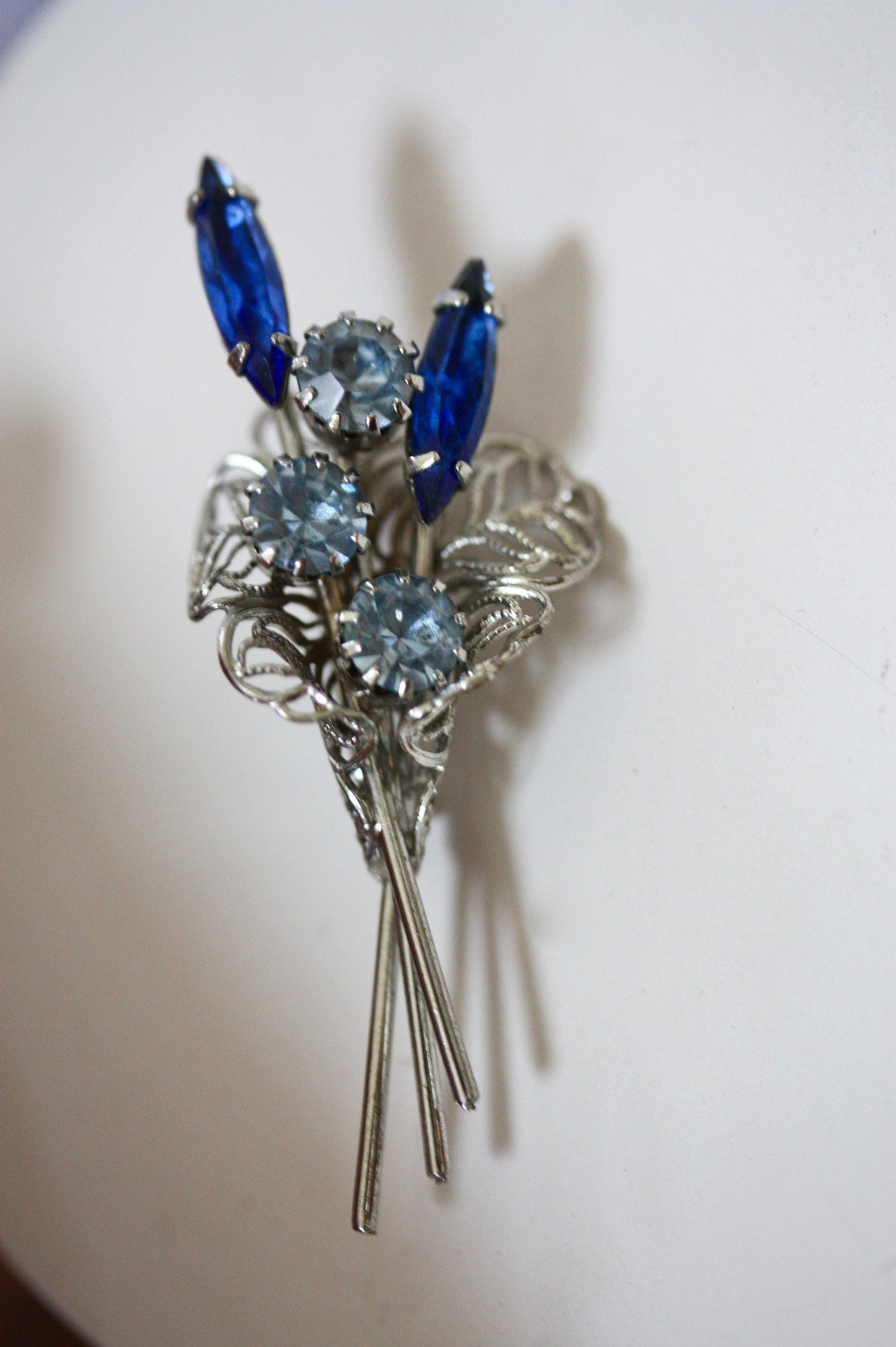 Charming vintage pin -  silver filigree bouquet of beautiful rhinestone & crystal flowers in shades of blue