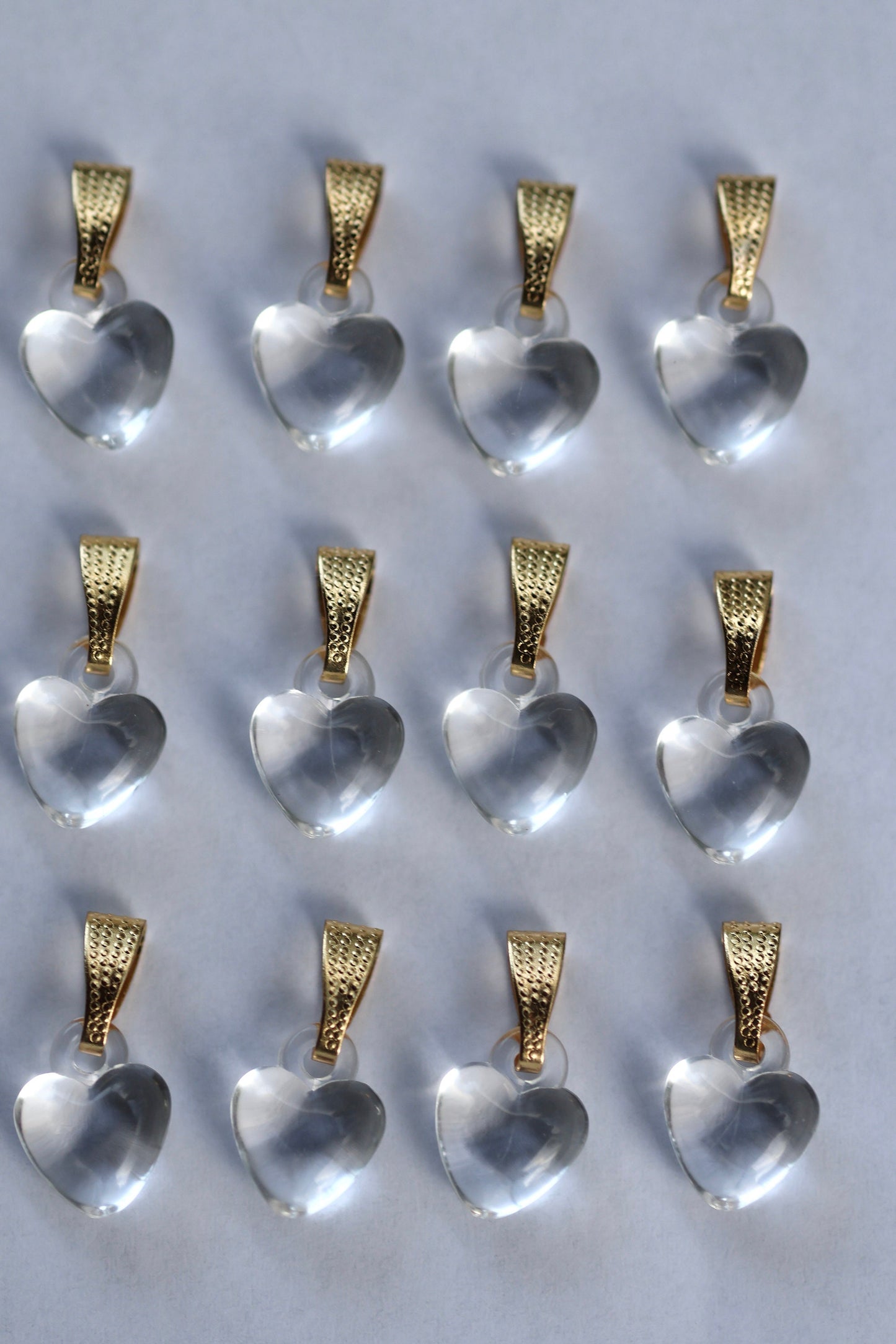 One dozen clear heart pendants - can be used as necklace pendants or for making earrings