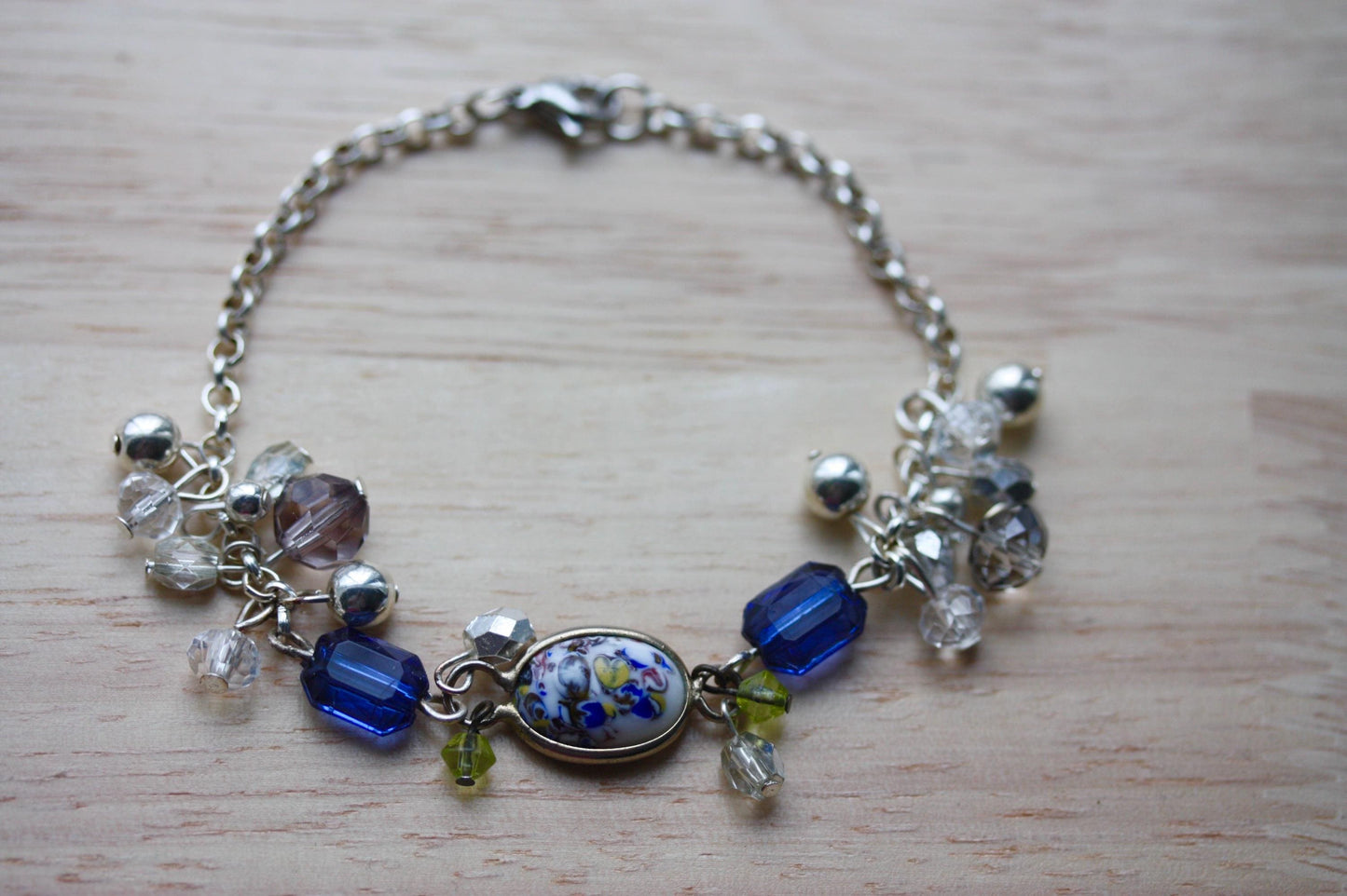 Handmade bracelet featuring a unique vintage art glass cabochon, royal blue faux crystals, yellow, pearl and clear crystal dangles - 7"
