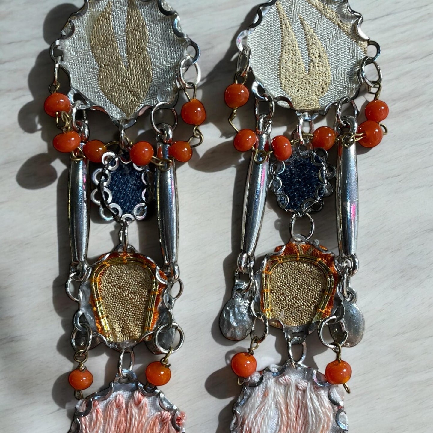 Orange and blue denim mixed media collage earrings with mixed fabrics and metals; Sterling silver ear wires