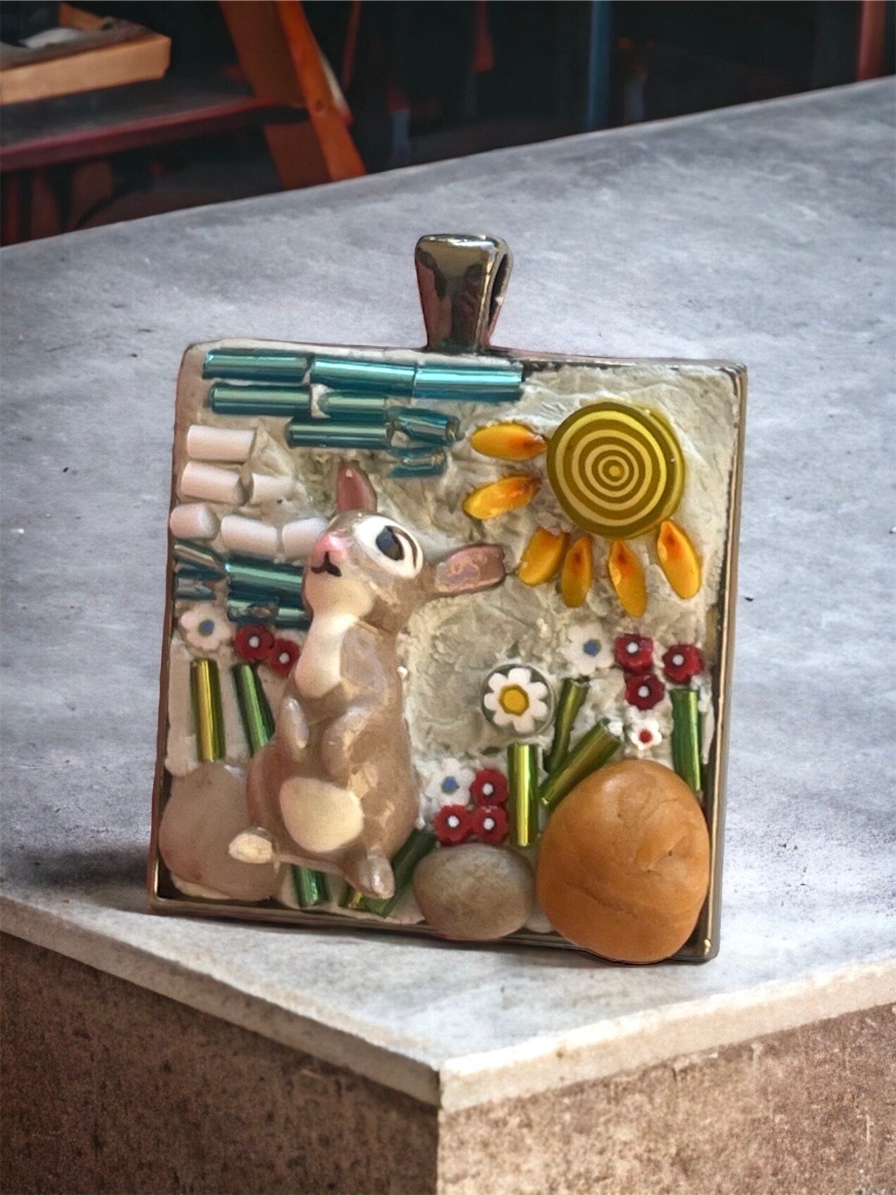 Handmade mixed material micro mosaic necklace - bone china rabbit sitting in sunshine with flowers, grass and rocks (from the Jersey shore)