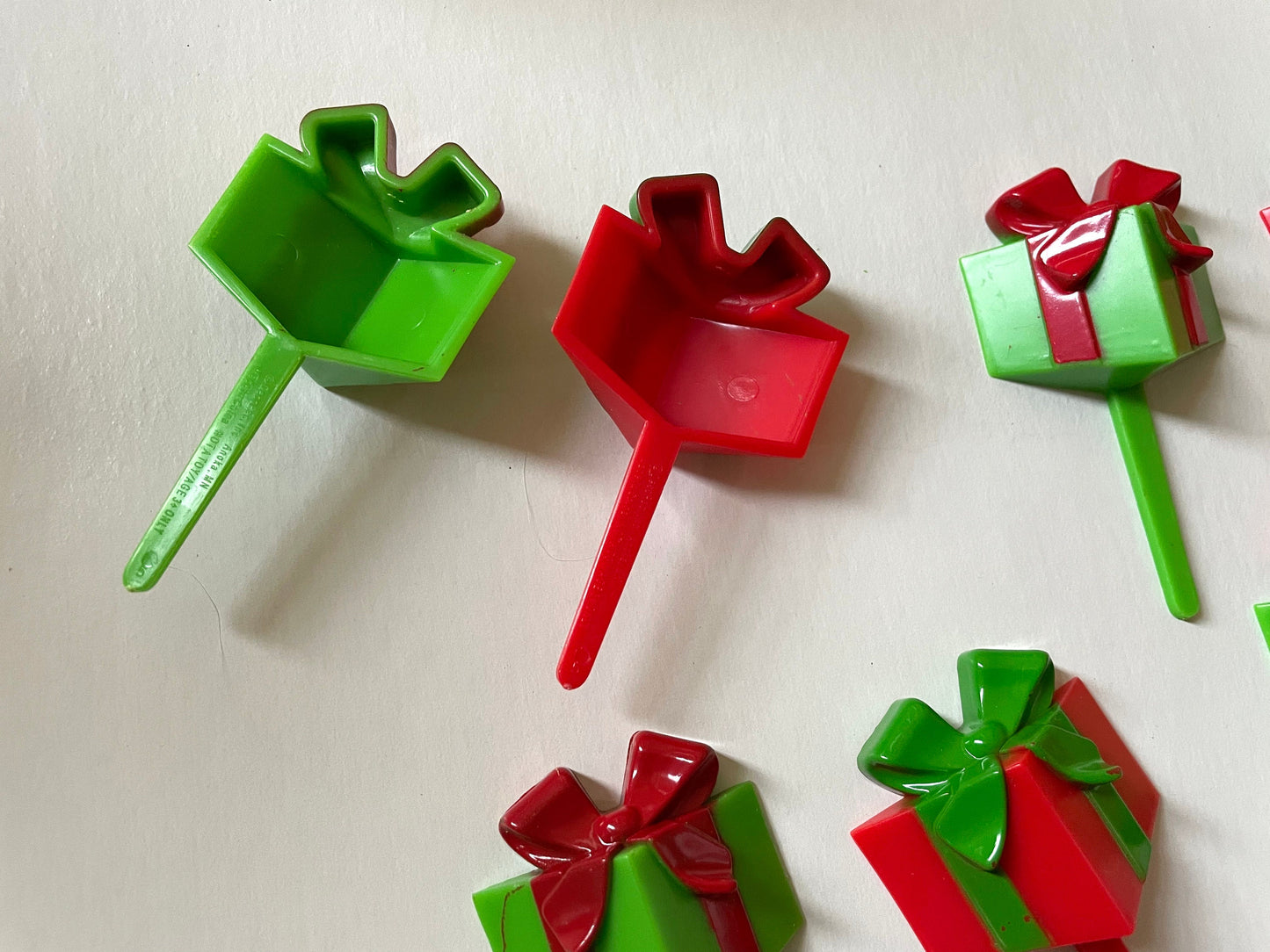 One dozen christmas cupcake toppers - Mix of red and green 3D plastic cake toppers - little wrapped packages with bows