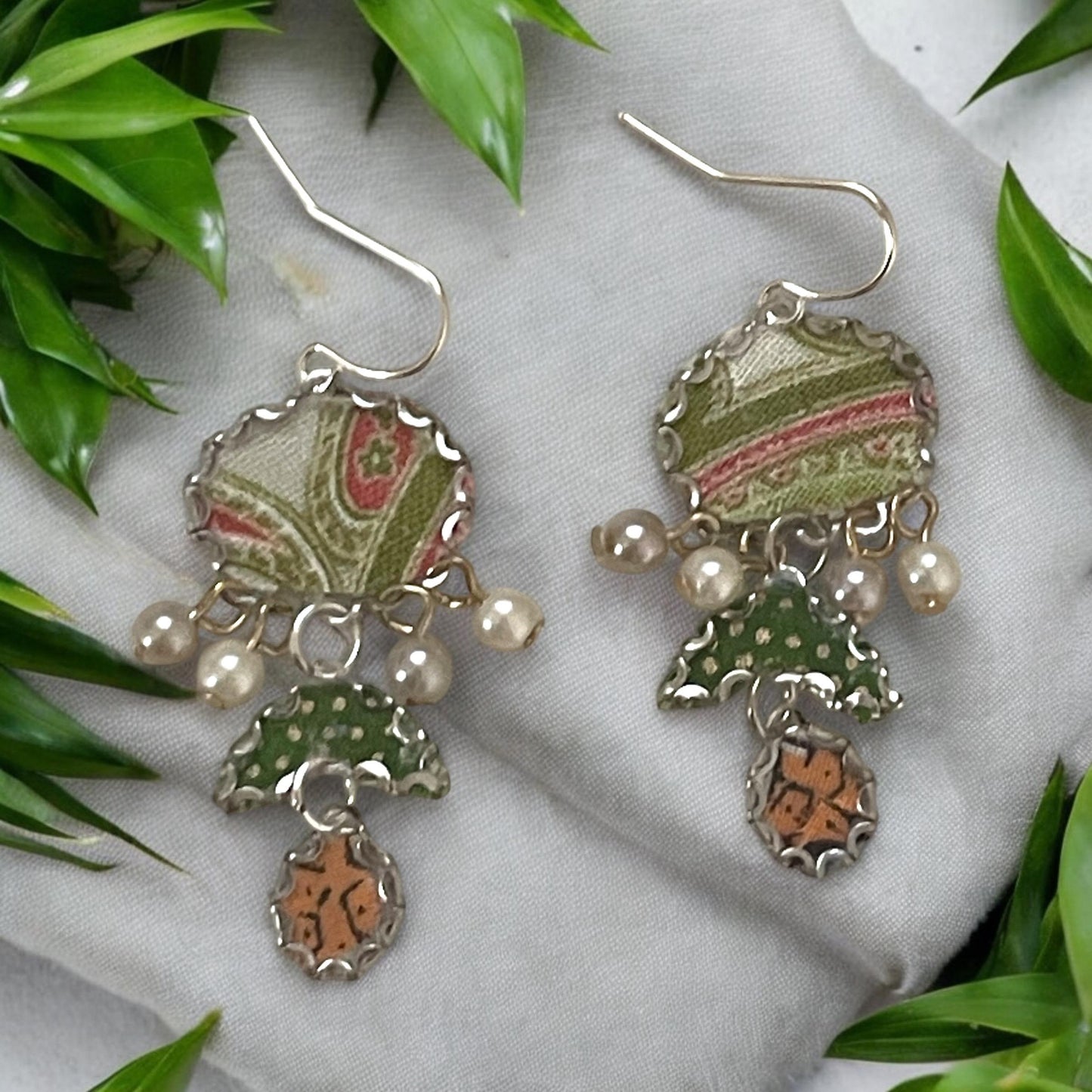 Handmade earrings featuring green and white polka dot fabric with peach and cream paisley and dangling faux pearls. Sterling ear wires.