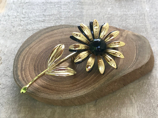 Large, long stemmed goldtone vintage flower pin with black center
