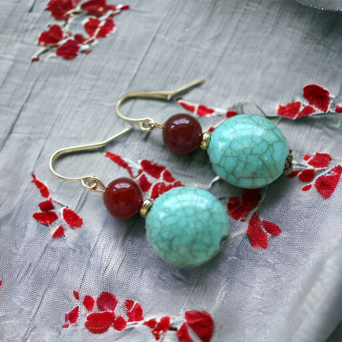 Dangle earrings made of faux turquoise and deep red glass
