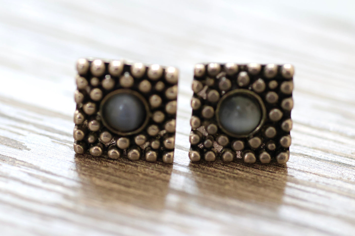 Textured metal vintage square stud earrings with blue glass inlay