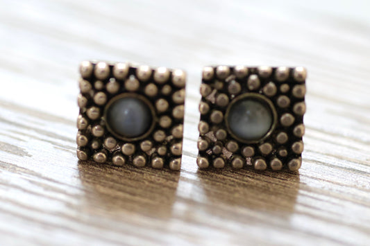Textured metal vintage square stud earrings with blue glass inlay