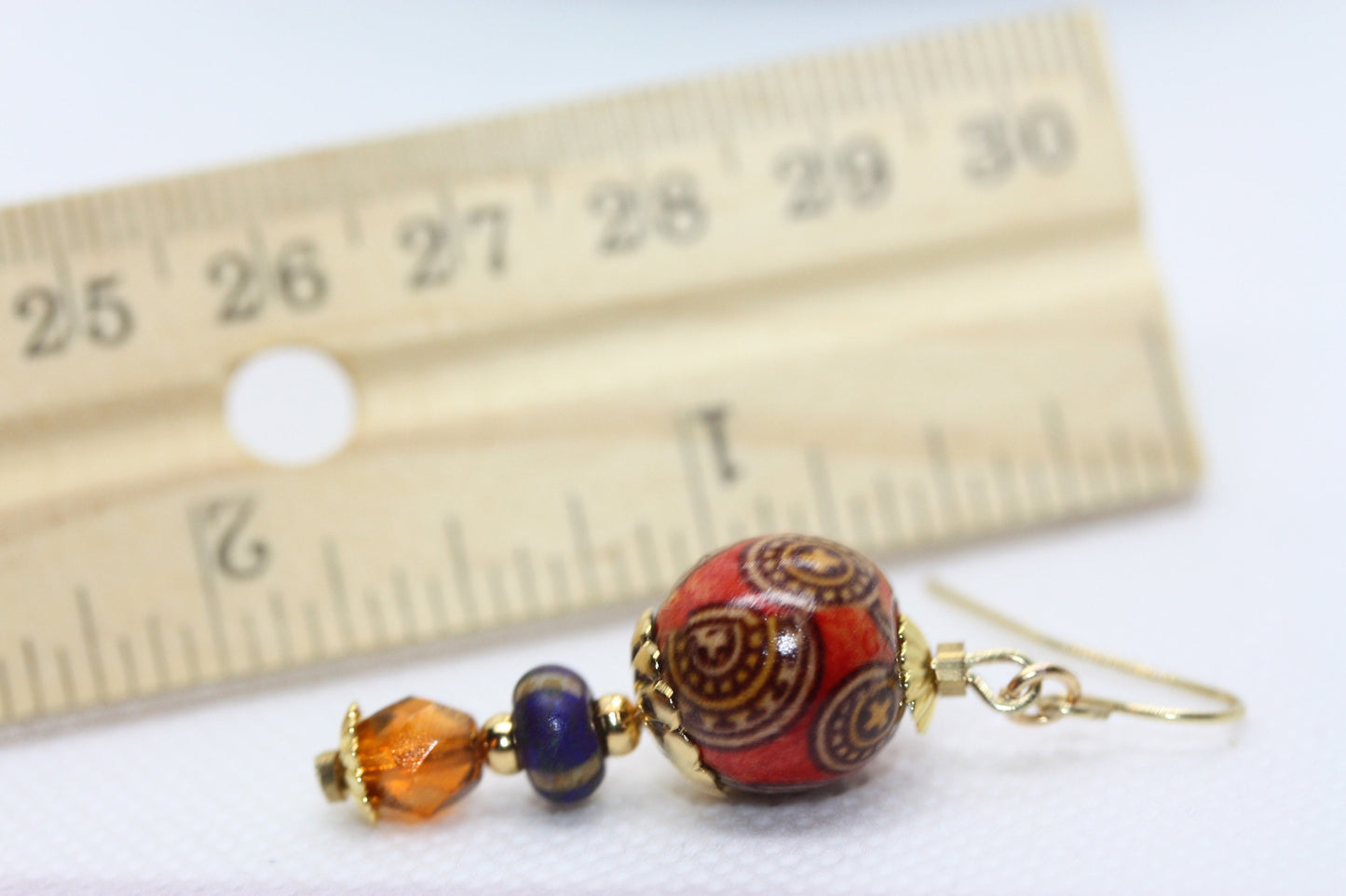 Burnt orange beaded earrings - paper covered beads, purple with cream stripes, orange fire polished crystals