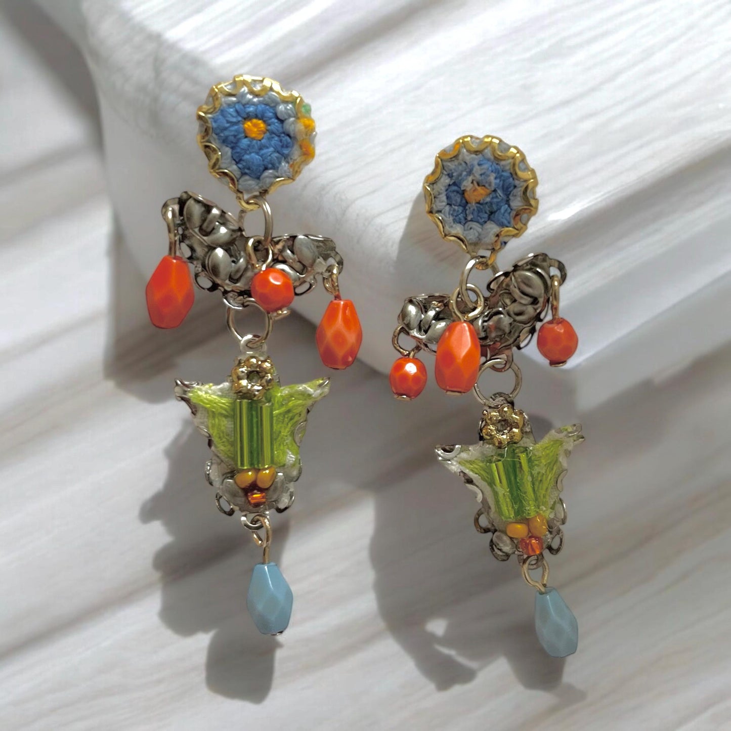 Handmade mixed media earrings made with embroidery from a vintage linen table runner, combined with glass, plastic, metal & fabric elements