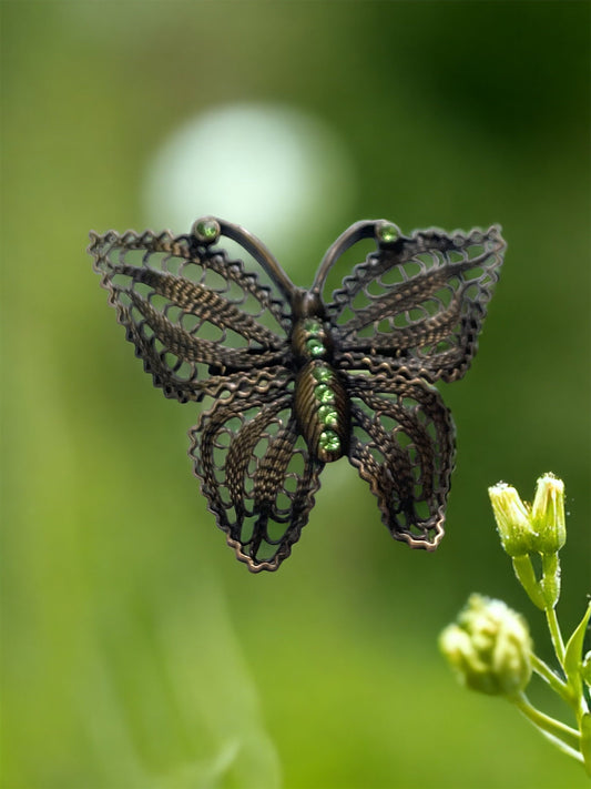 Detailed vintage filigree butterfly pin with tiny emerald green rhinestones