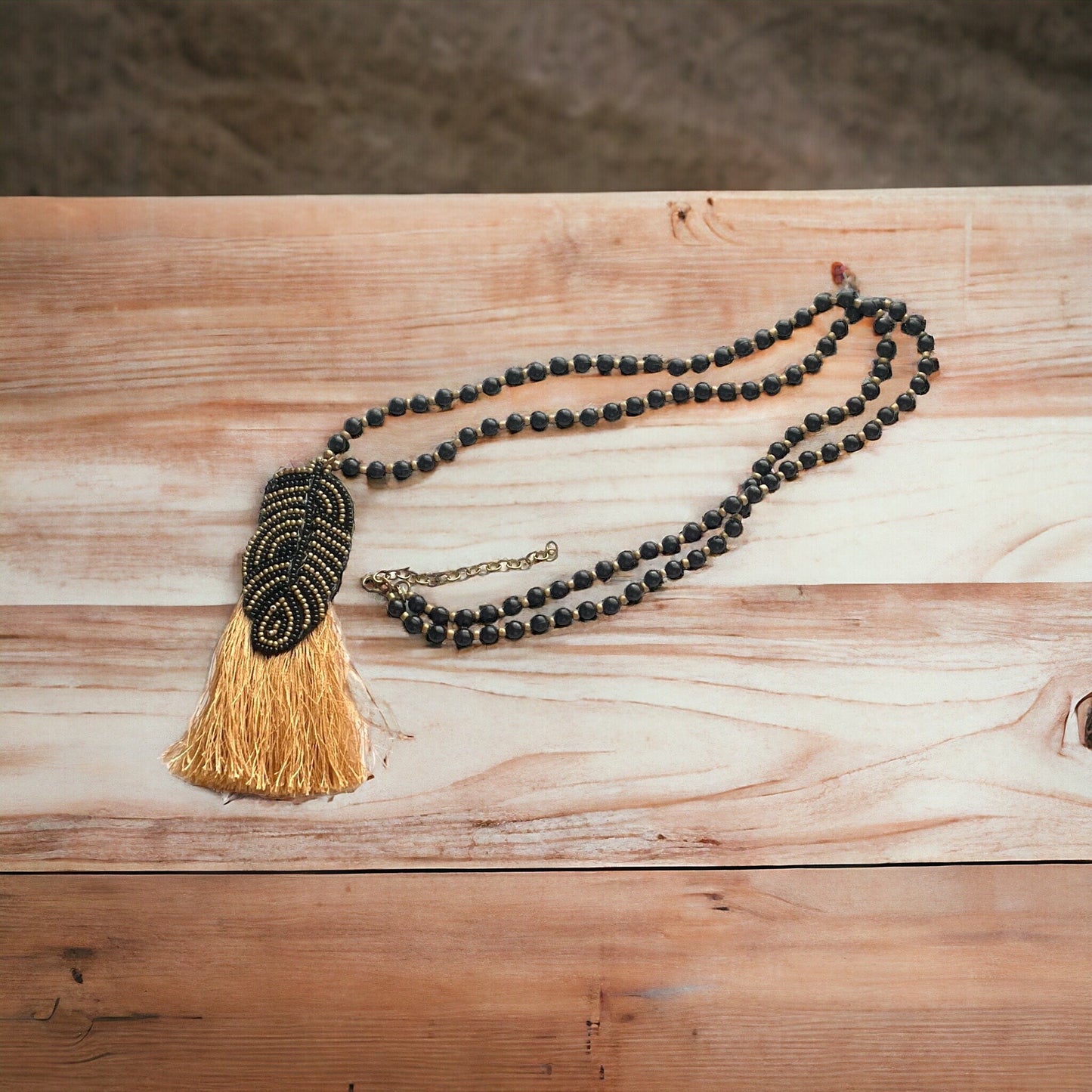 Stunning and unique hand beaded vintage artisan black and gold tassel necklace