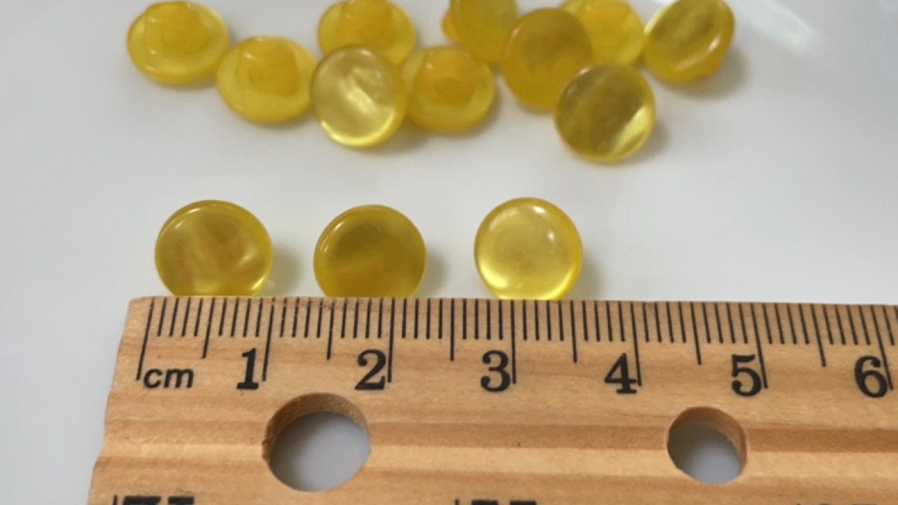 One dozen round yellow gold pearlescent vintage buttons