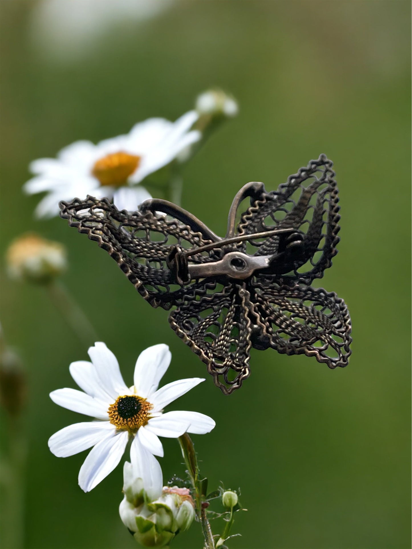 Detailed vintage filigree butterfly pin with tiny emerald green rhinestones