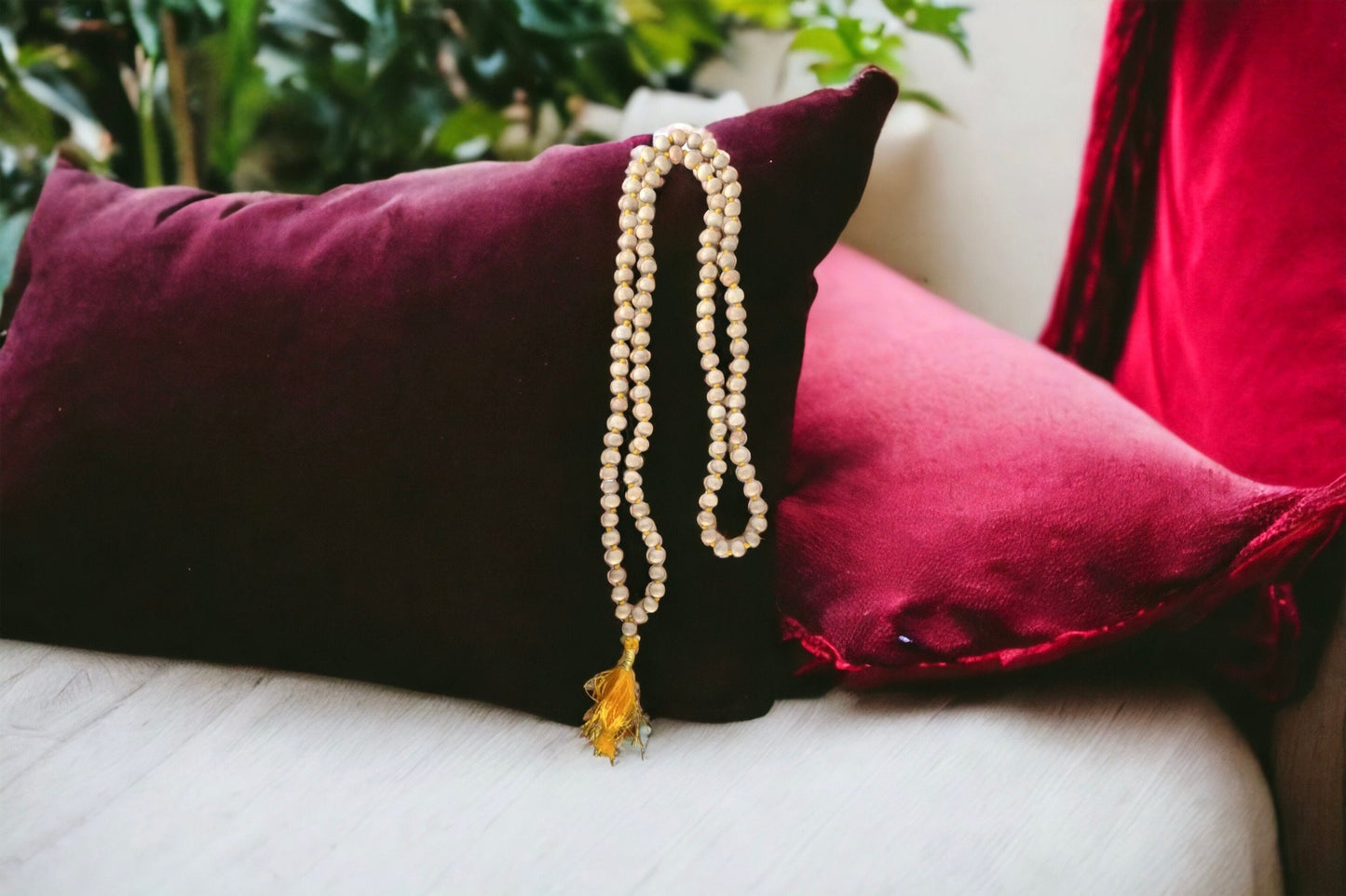 Knotted natural wood prayer bead necklace with golden yellow tassel