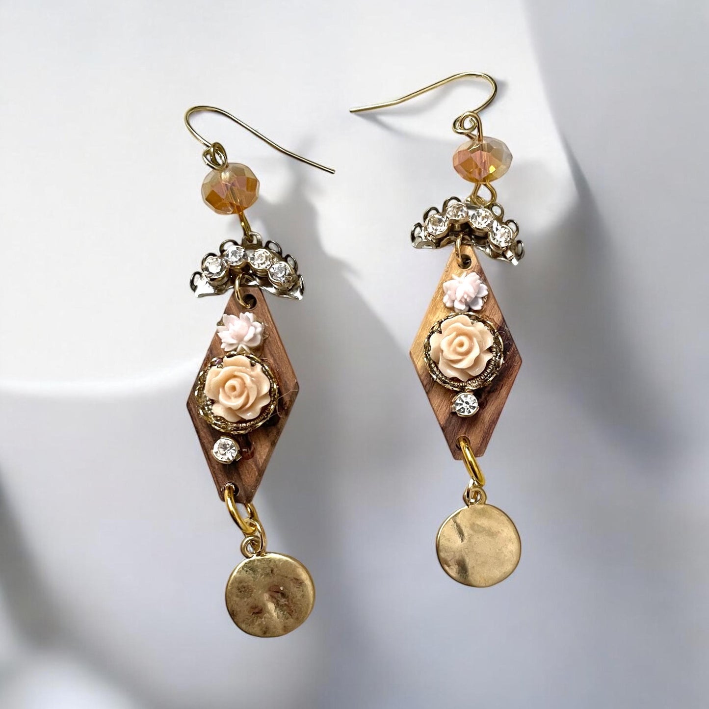 Dangle earrings with wood diamonds from a broken vintage rosary, etched roses, rhinestone, crystals and hammered discs. Sterling ear wires.