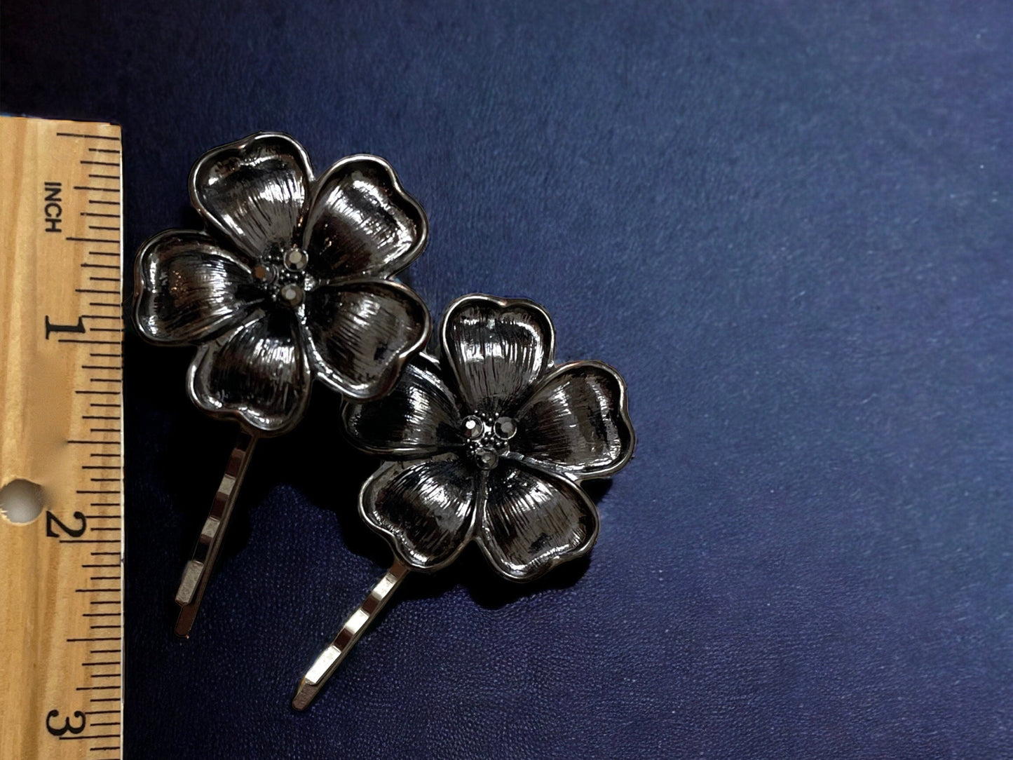 Pair of black flower hair pins with rhinestone centers