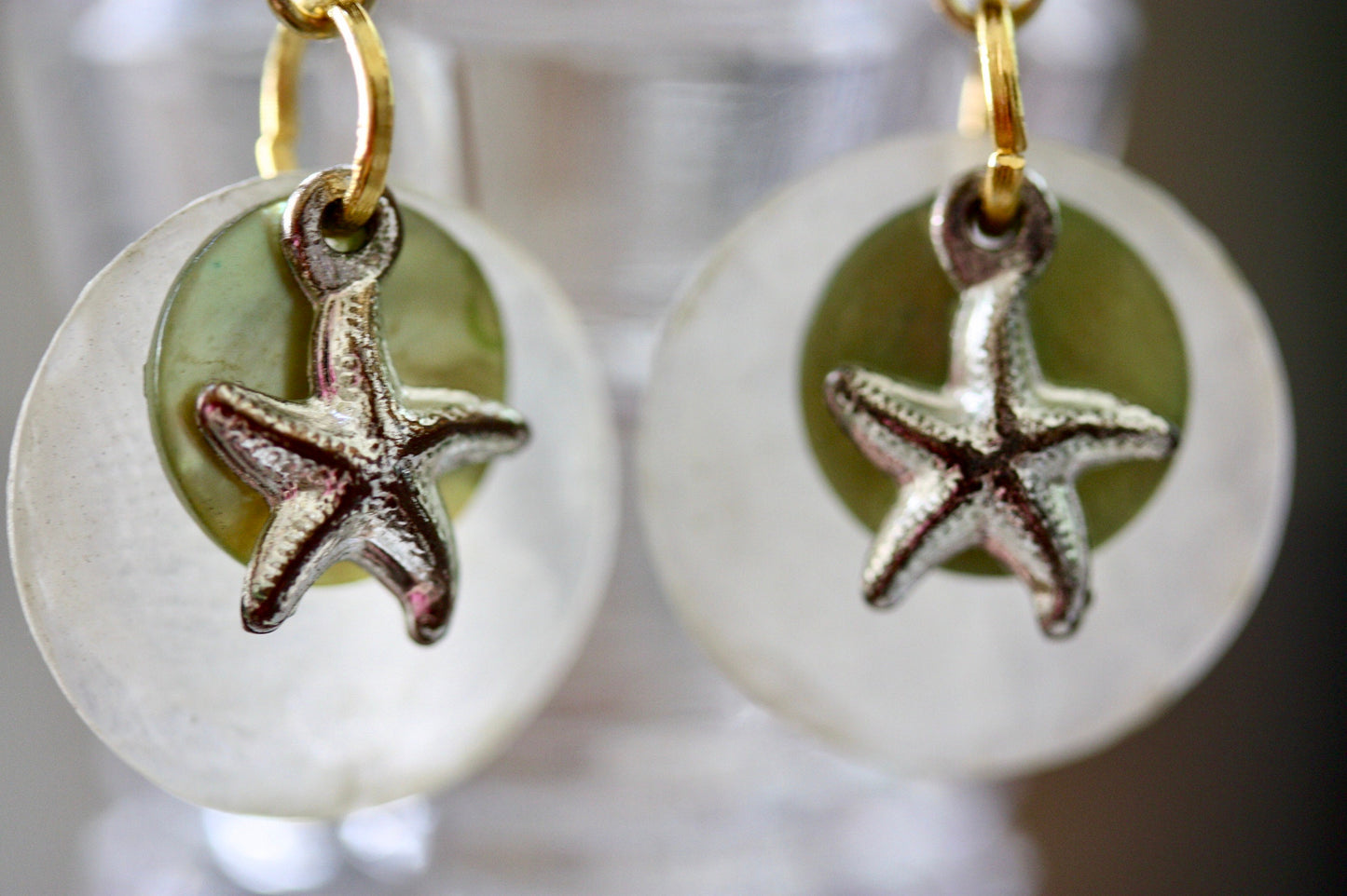 Mixed materials - green mother of pearl, metal starfish and yellow wood - beach themed dangle earrings