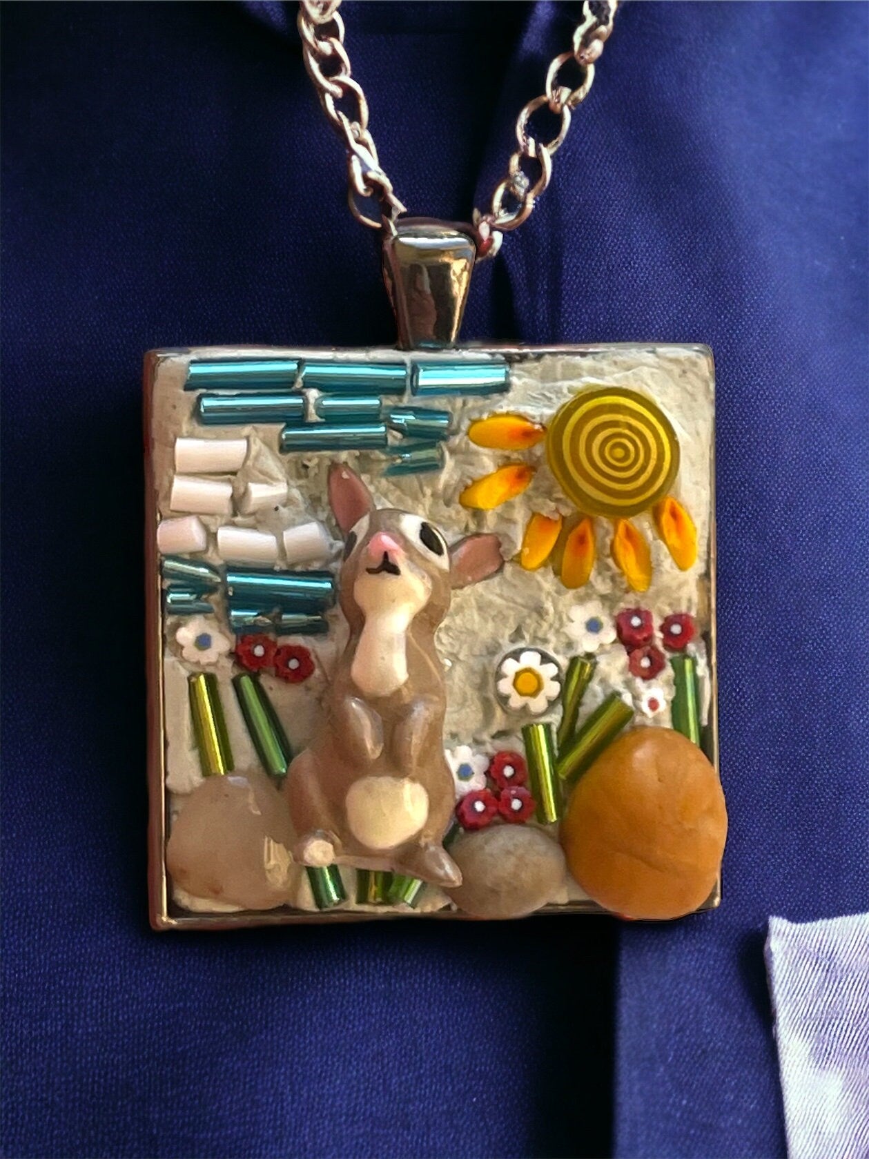 Handmade mixed material micro mosaic necklace - bone china rabbit sitting in sunshine with flowers, grass and rocks (from the Jersey shore)