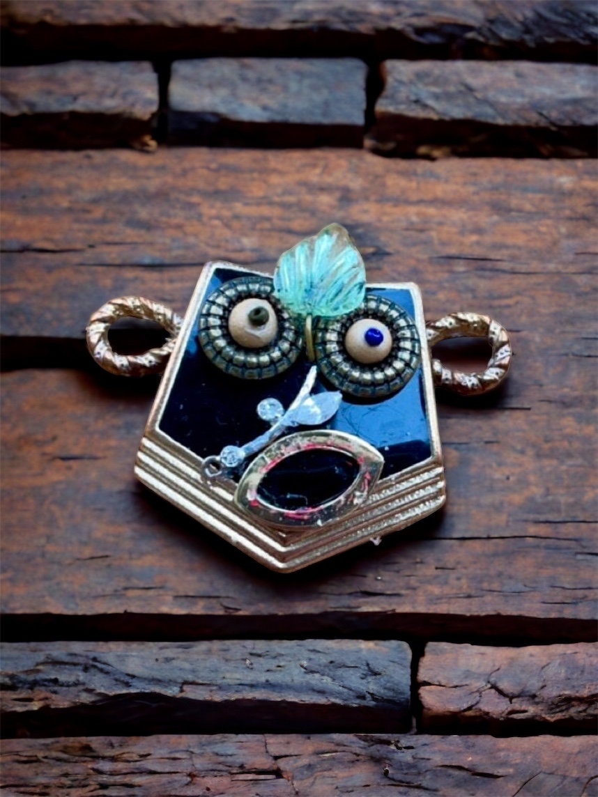 This monkey is a really cool assemblage art piece - it can be transformed into a necklace pendant, pin, magnet, small ornament or ring