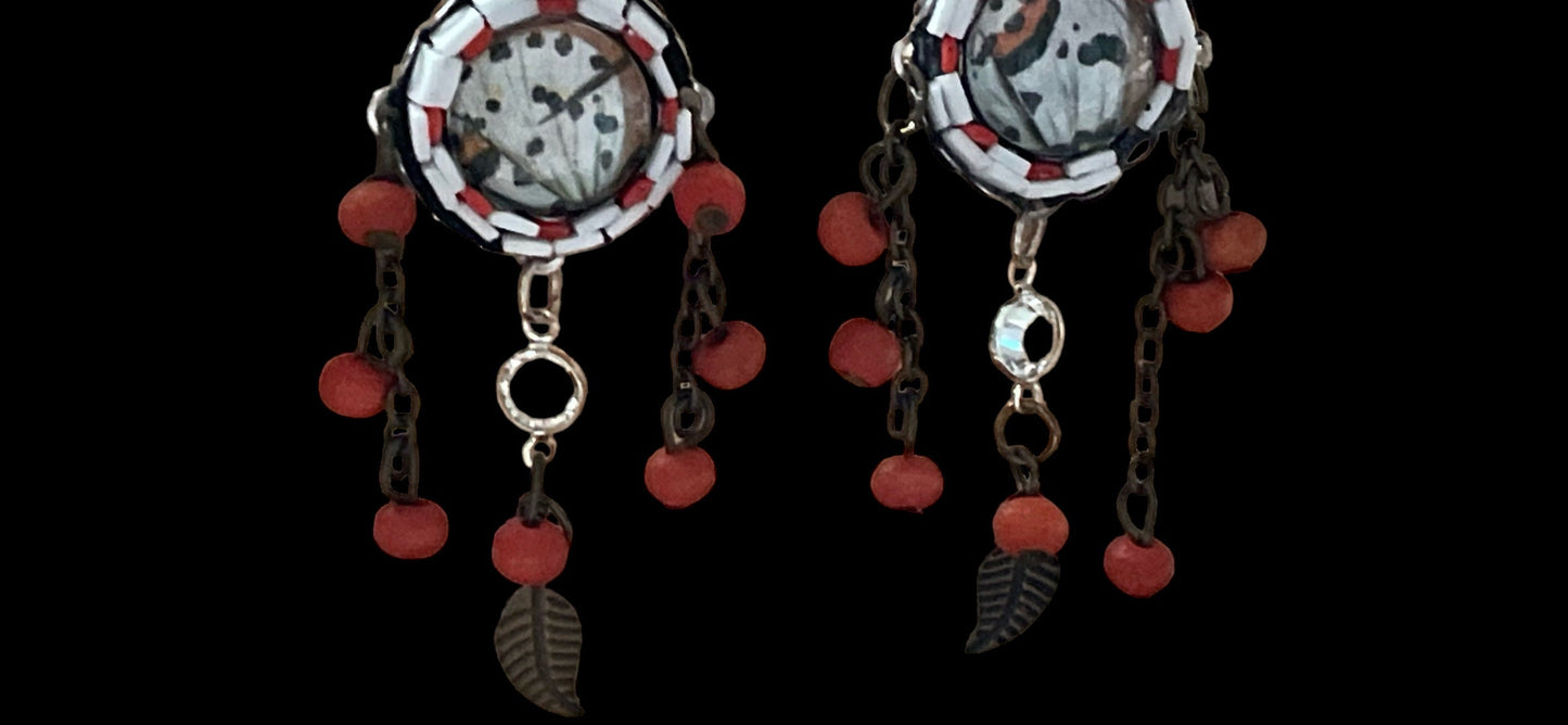 Hand cut micro mosaic millefiori glass dangle earrings surrounding butterfly wing image with orange wood dangles and feather charms