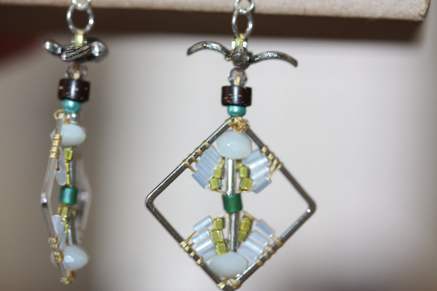 Birds taking flight - intricate beadwork seed bead dangle earrings on diamond-shaped base with flying bird embellishments