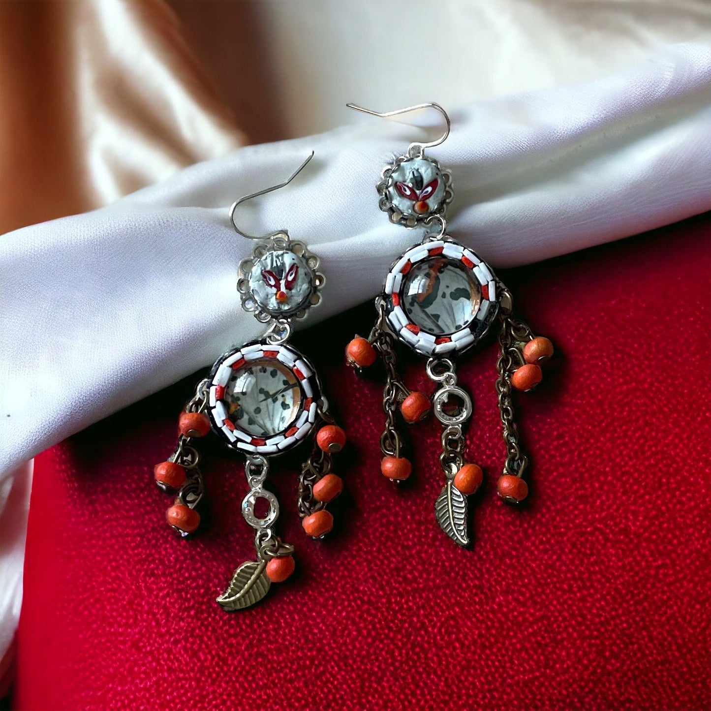 Hand cut micro mosaic millefiori glass dangle earrings surrounding butterfly wing image with orange wood dangles and feather charms