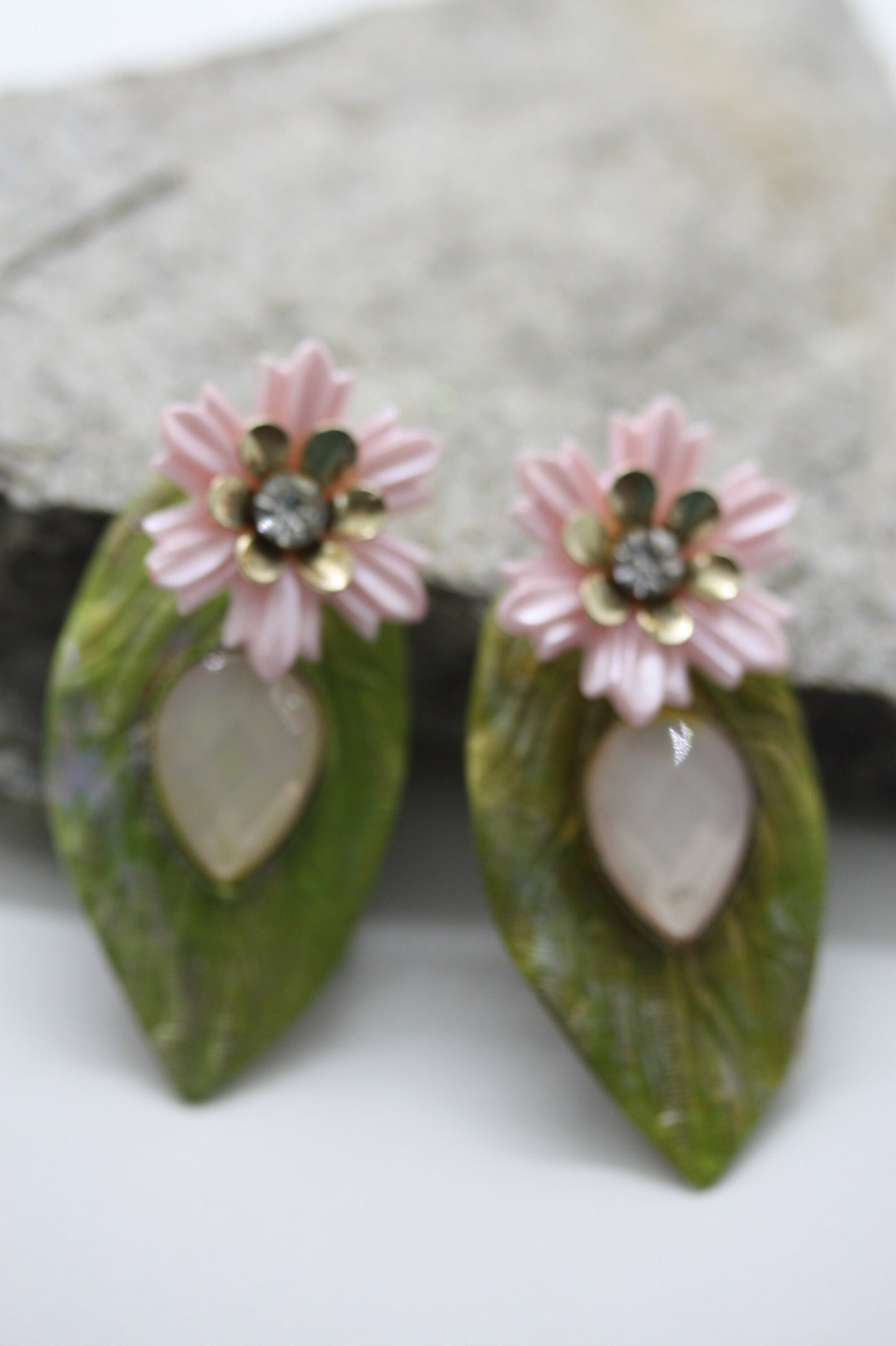 Hand painted leaf earrings with inlaid cabochan, vintage mixed material pink and metal flowers and capped off with rhinestone center