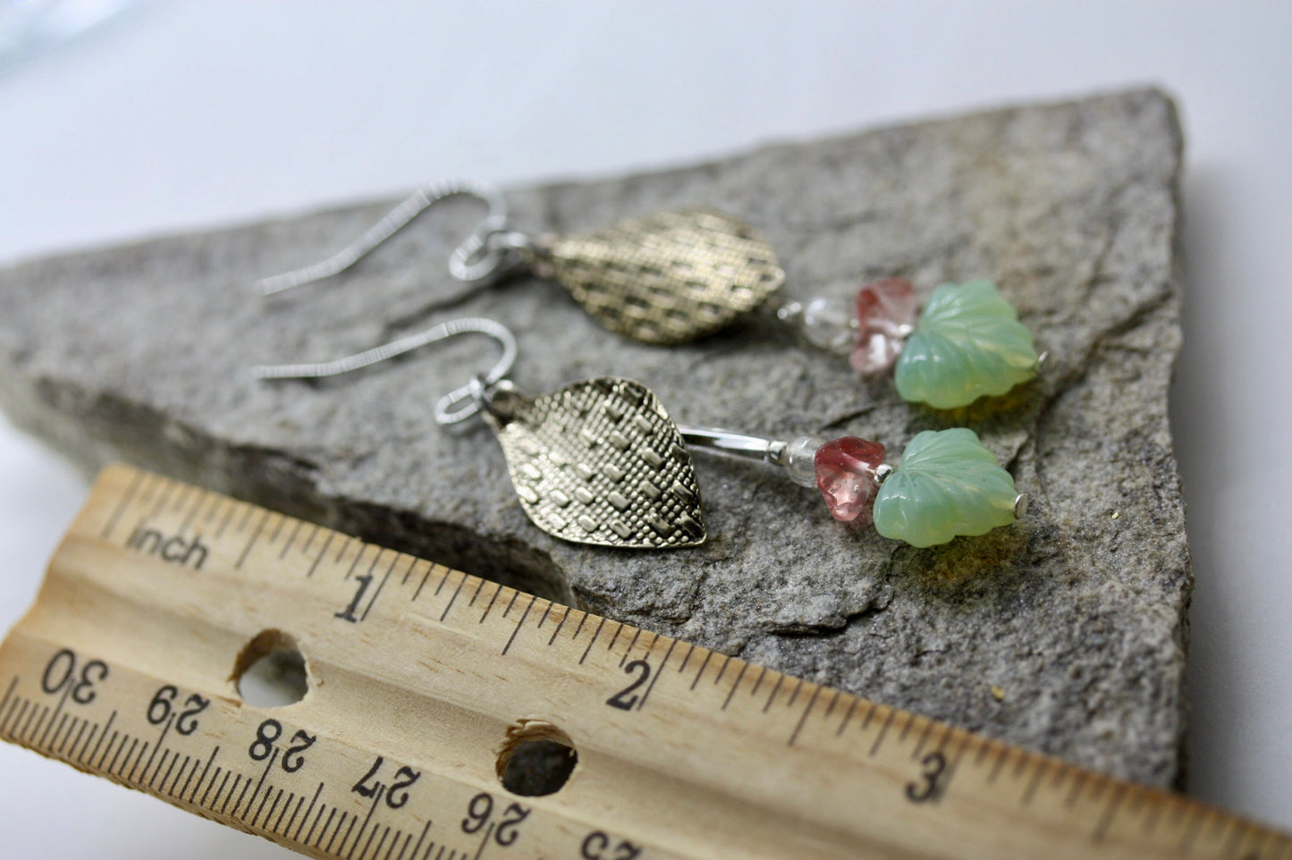 Handmade dangle earrings made of vintage textured metal leaves, pink gemstone chips and light green opaline glass ginko flower leaves