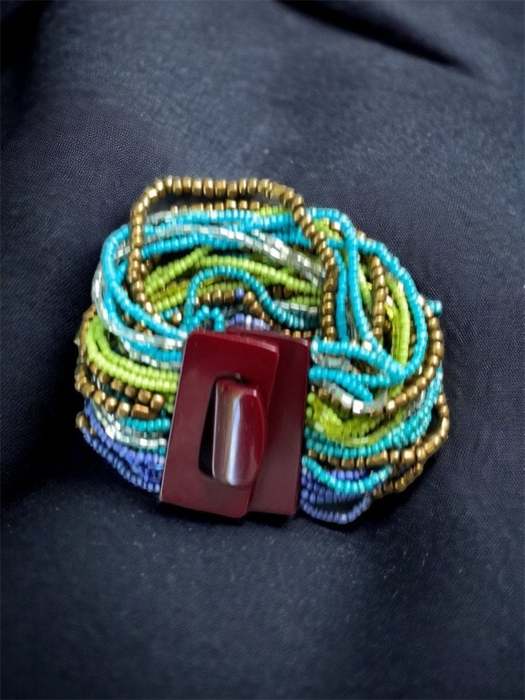 Stunning vintage bracelet - loaded with dozens of strands of tiny glass beads - plastic or bakelite closure?