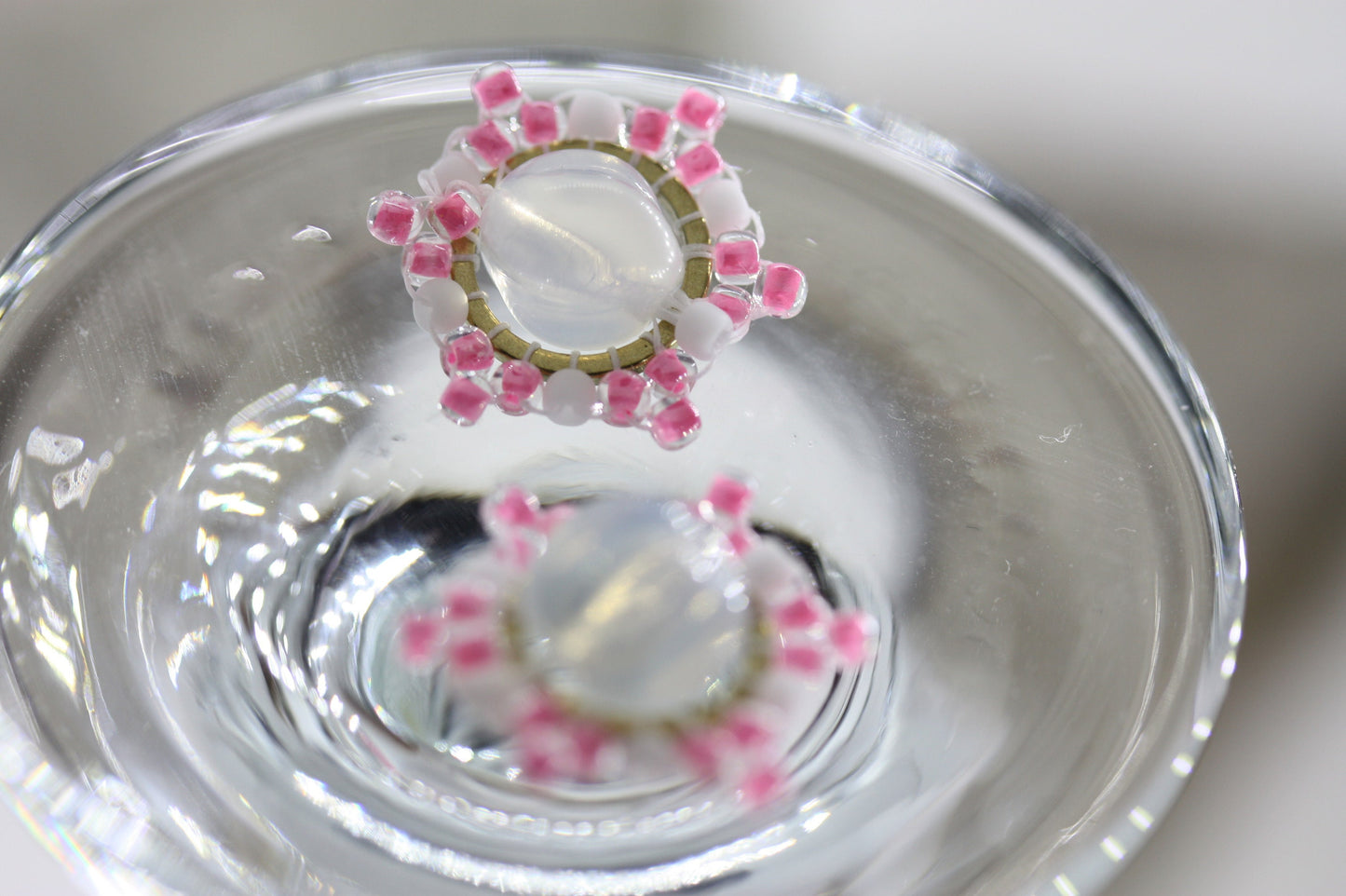 Hand beaded stud earrings - pink and white beadwork around transluscent opalescent glass bead