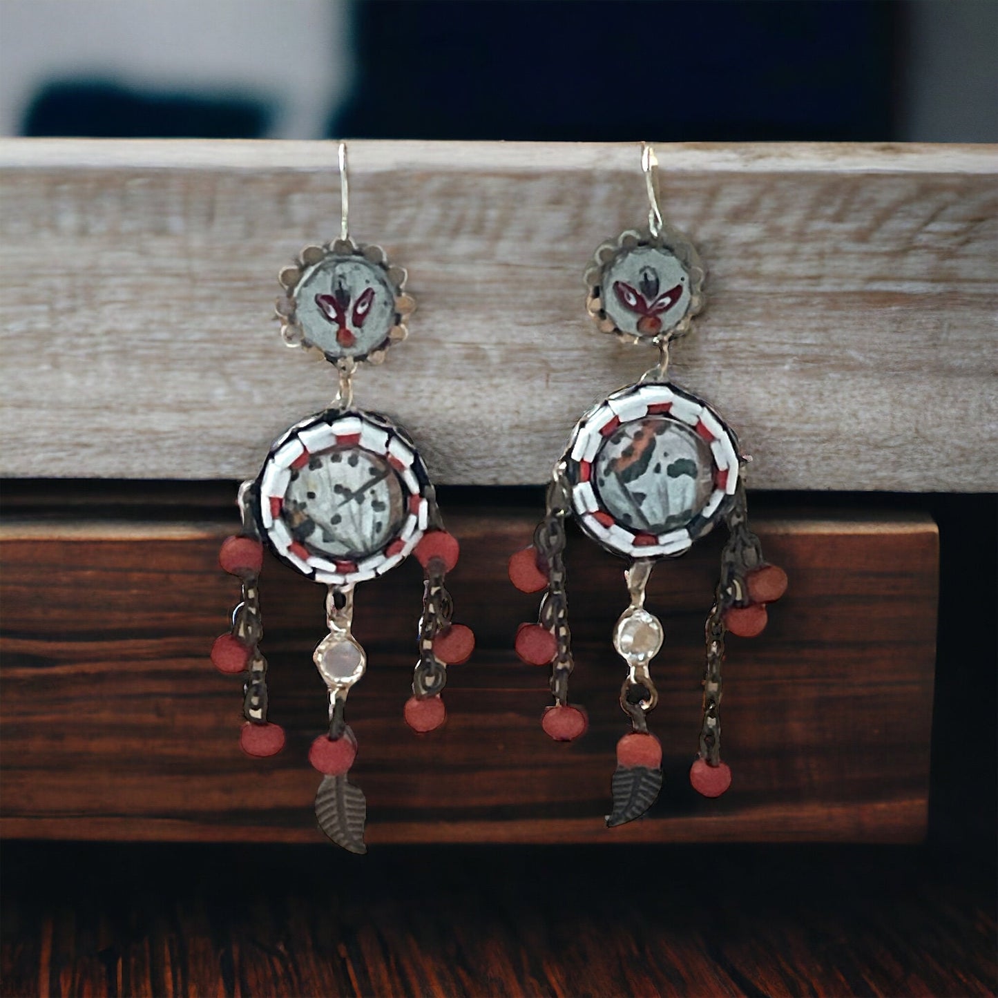Hand cut micro mosaic millefiori glass dangle earrings surrounding butterfly wing image with orange wood dangles and feather charms