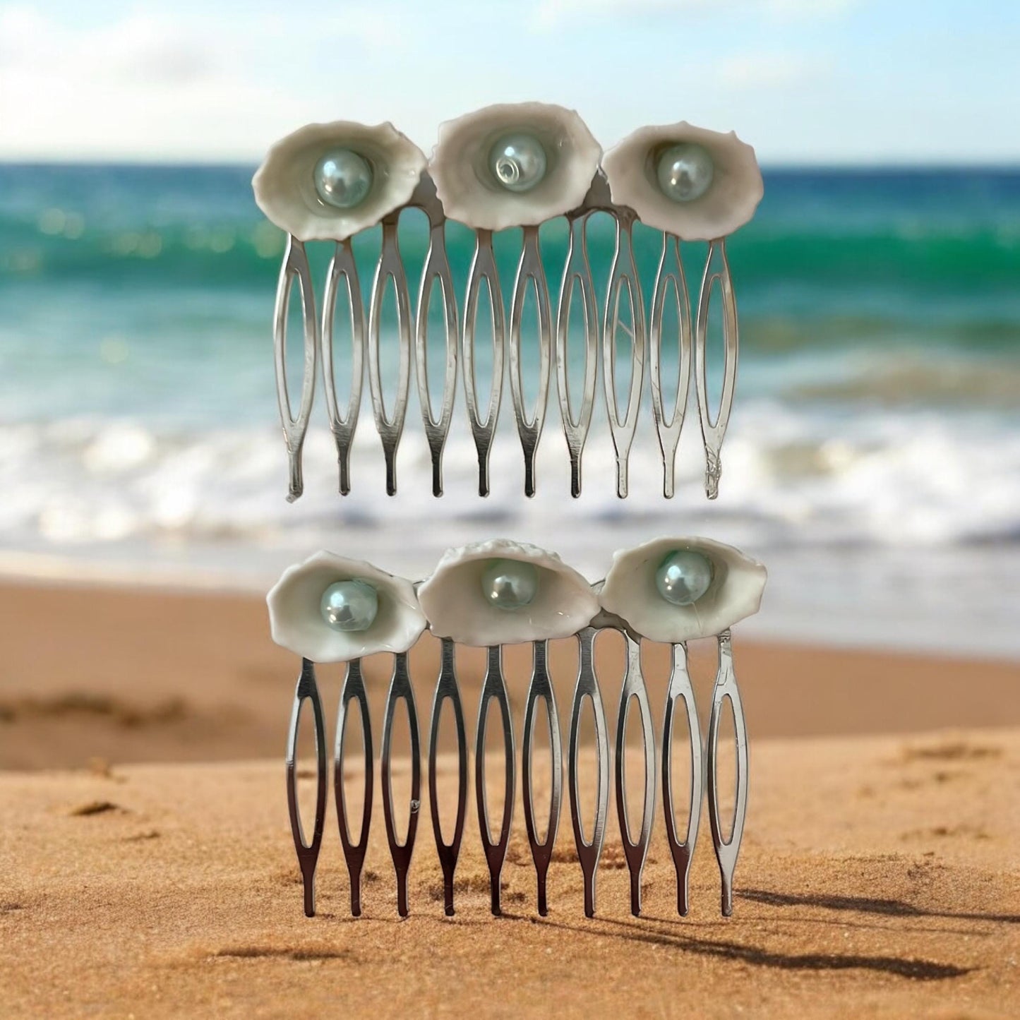 Pair of Hair combs made of white shells with light blue pearl centers
