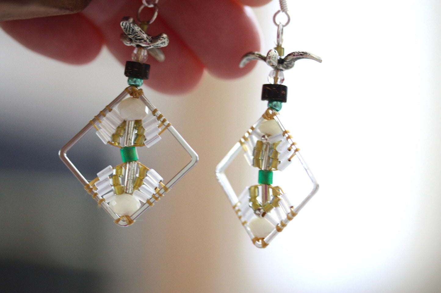 Birds taking flight - intricate beadwork seed bead dangle earrings on diamond-shaped base with flying bird embellishments