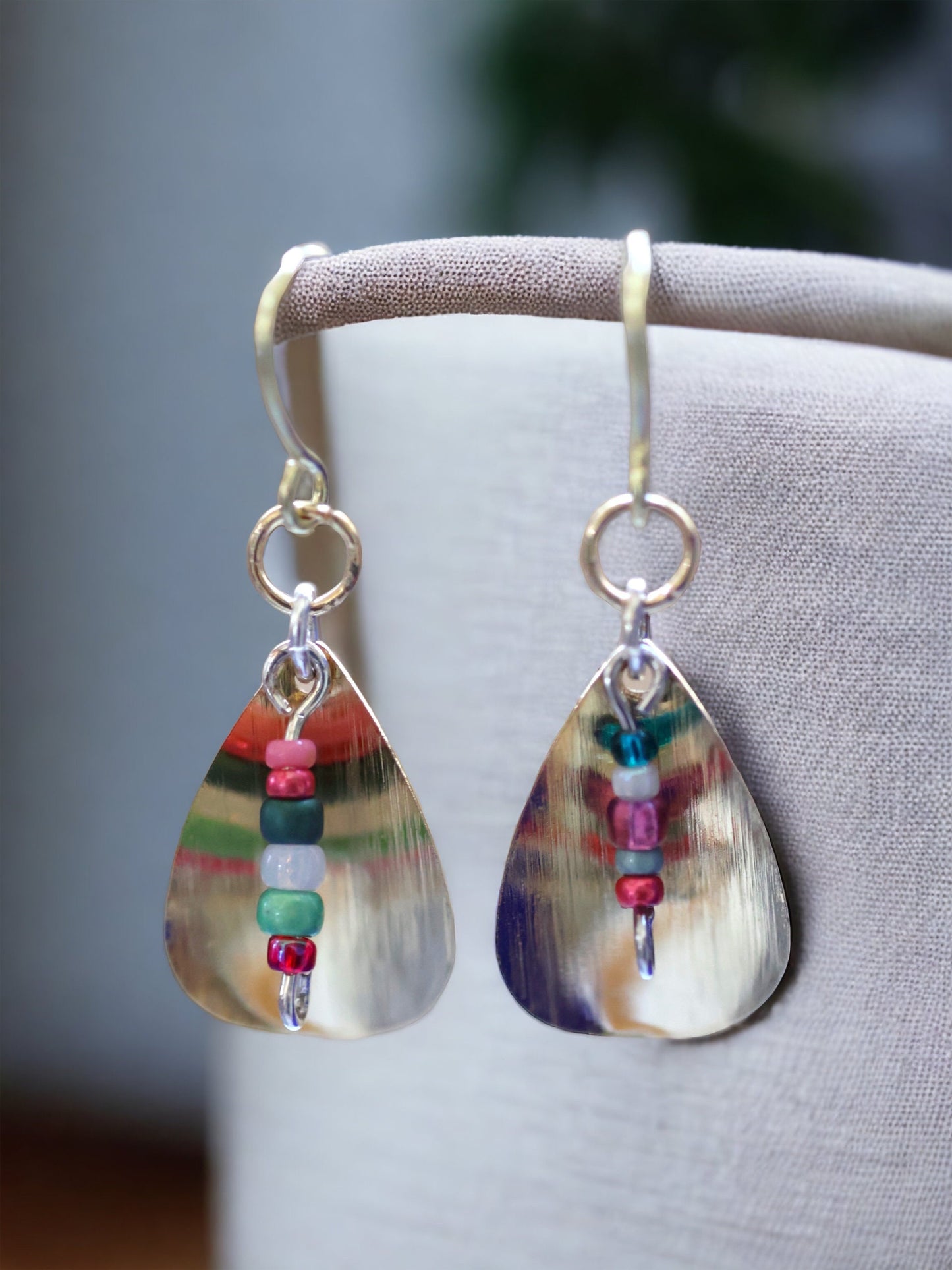 Gently curved silver leaf drop earrings with colored glass seed bead dangles
